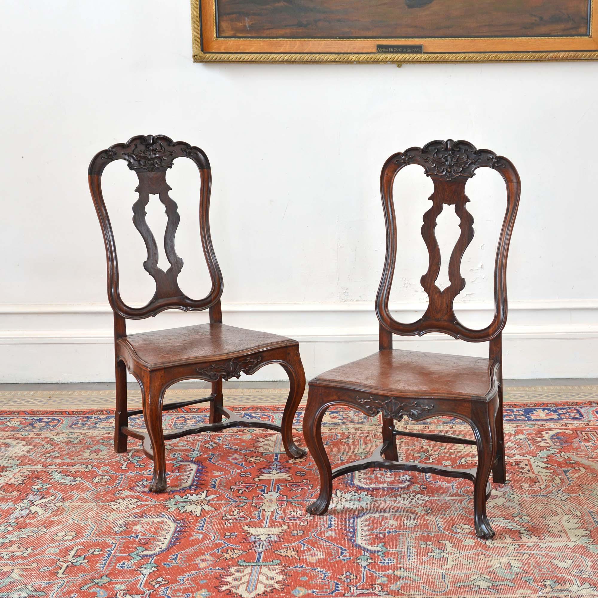 Paire de chaises d'appoint rococo portugaises à haut dossier en bois de rose. En palissandre brésilien, avec des plateaux moulés et sculptés de rinceaux et de feuillages, sur des cannelures percées et des sièges en cuir ancien. Il repose sur des