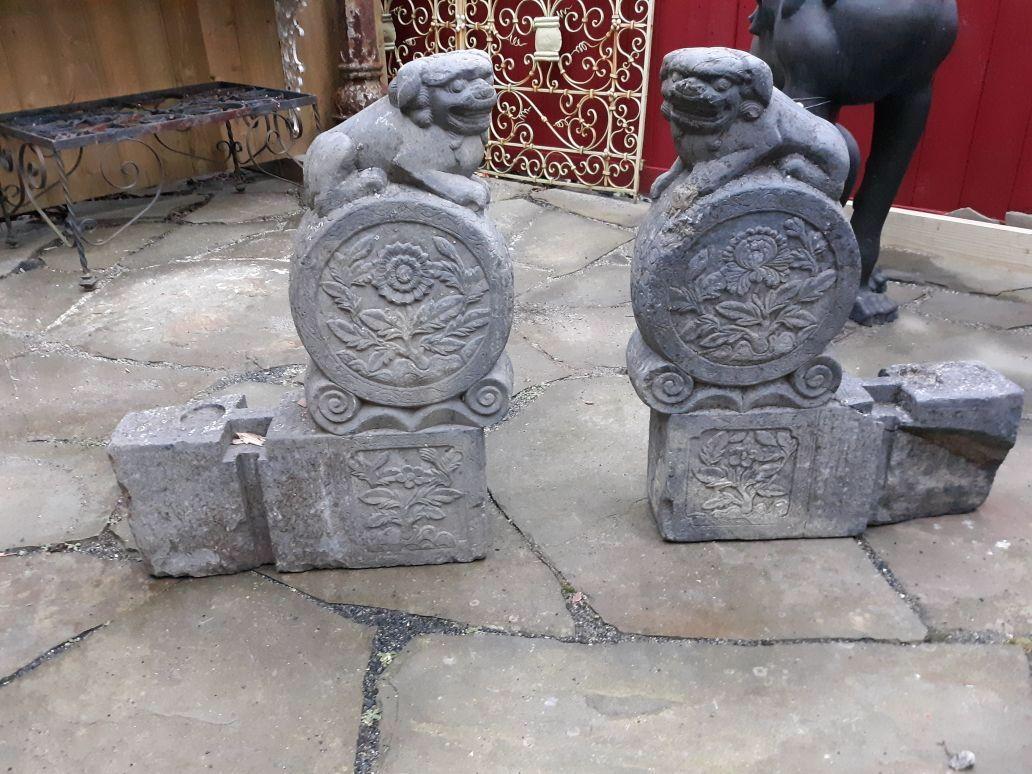 A Large pair of pre-1800 carved grey stone foo dog carvings, probably architectural elements, 27.5 inches tall. Old stabile crack in one, old restored paw on the other, if good condition consistent with age.