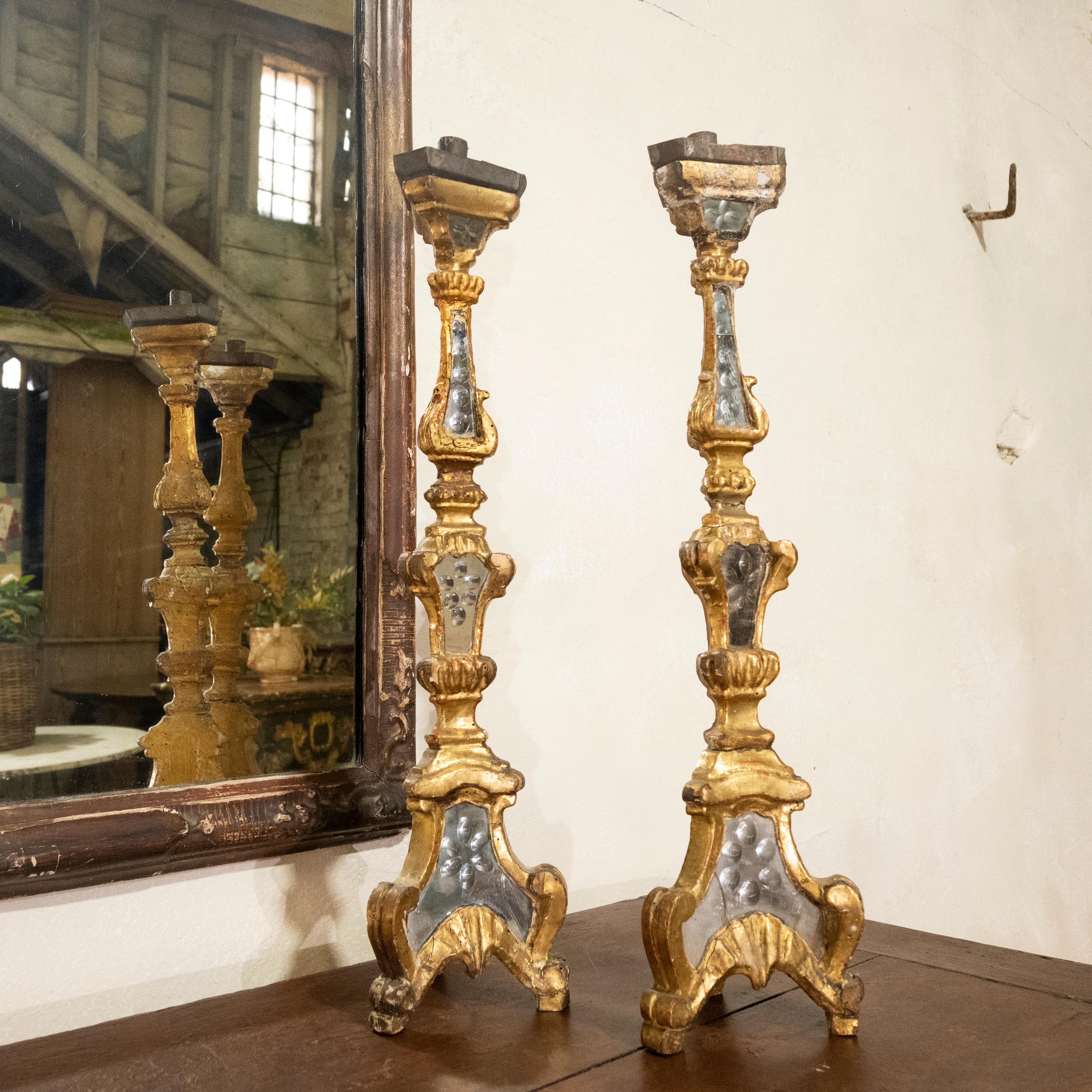 An exceptional pair of early 18th-century gilded and mirrored etched glass Venetian altar - candlesticks. Of triangular form, demonstrating insets of original etched mirror glass to reflect light, a fabulous addition to this elegant design.