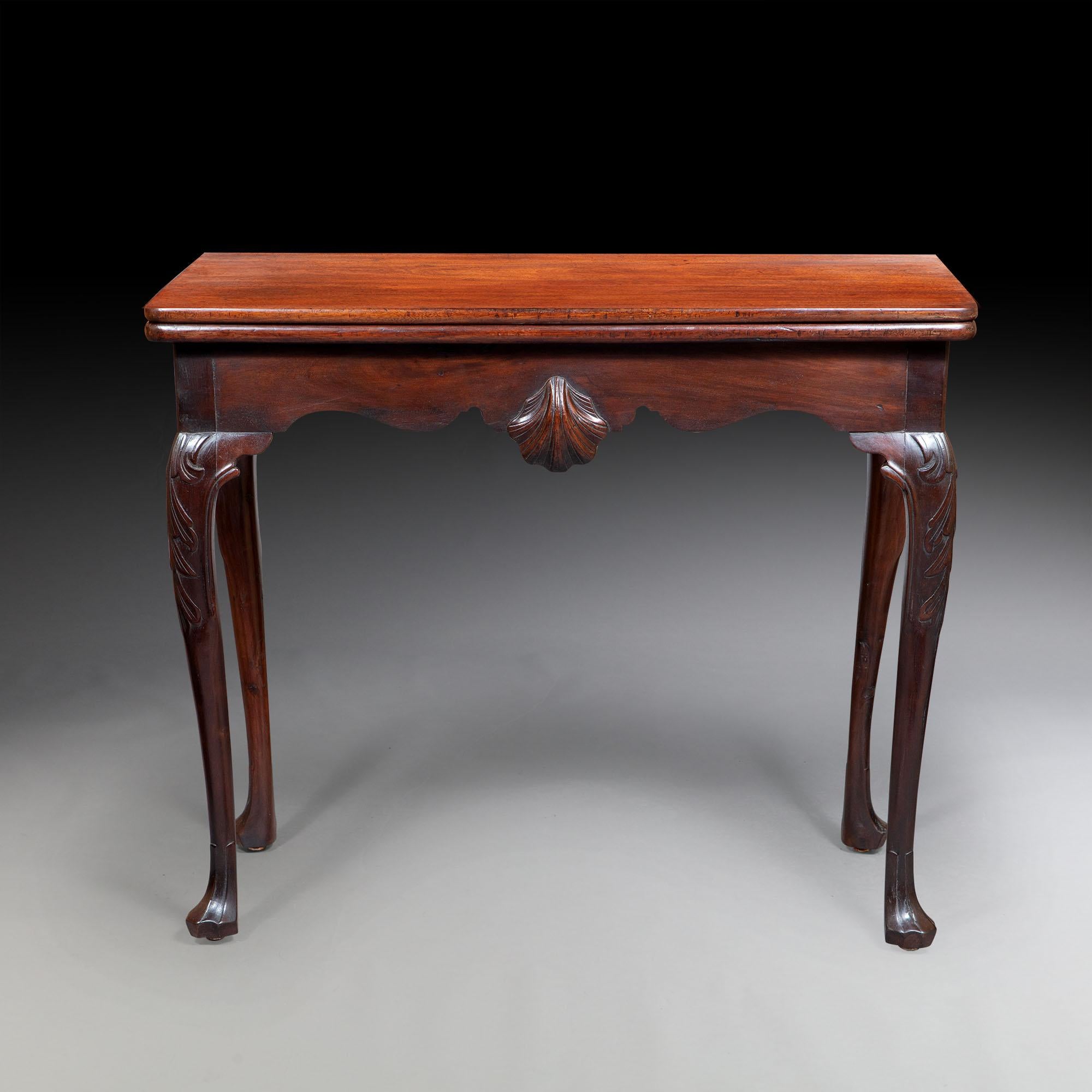 A fine pair of 18th century Irish brown mahogany tea tables. The rectangular tops above a shaped frieze, with a central scallop shell, resting on shell carved cabriole legs with lions paw feet.
Irish, circa 1760.

 
