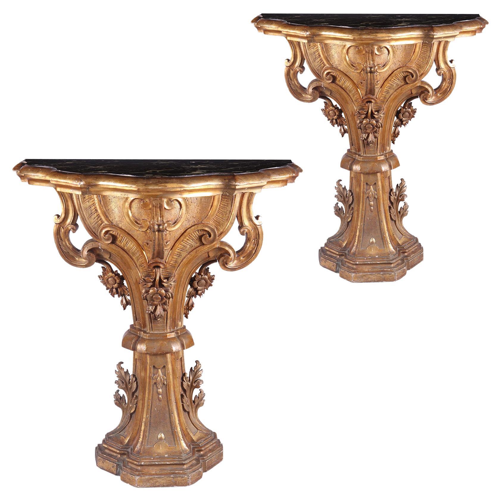 A pair of 18th century Italian carved gilt wood console tables  For Sale