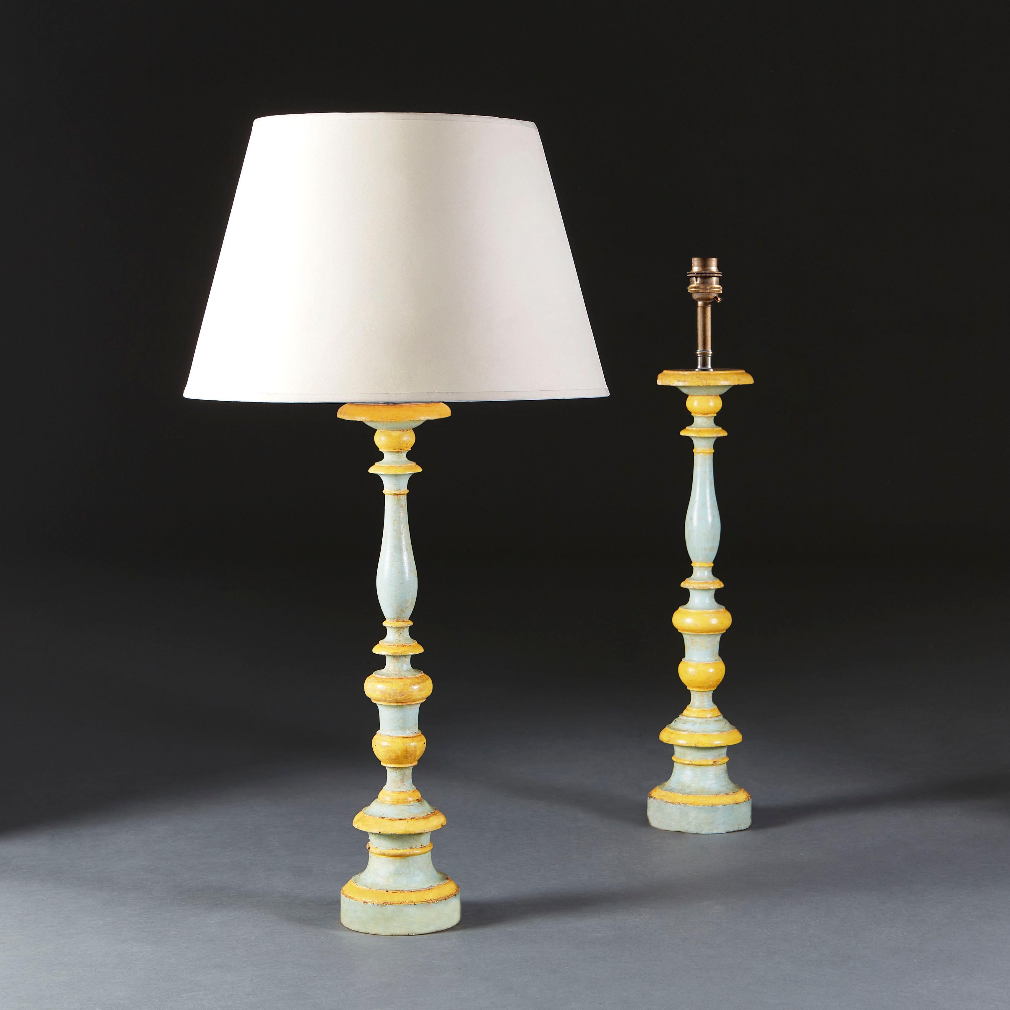 A unusual pair of late eighteenth century turned candlesticks, with original blue and yellow paintwork, now converted as lamps.

Currently wired for the UK.

Please note: Lampshades not included.