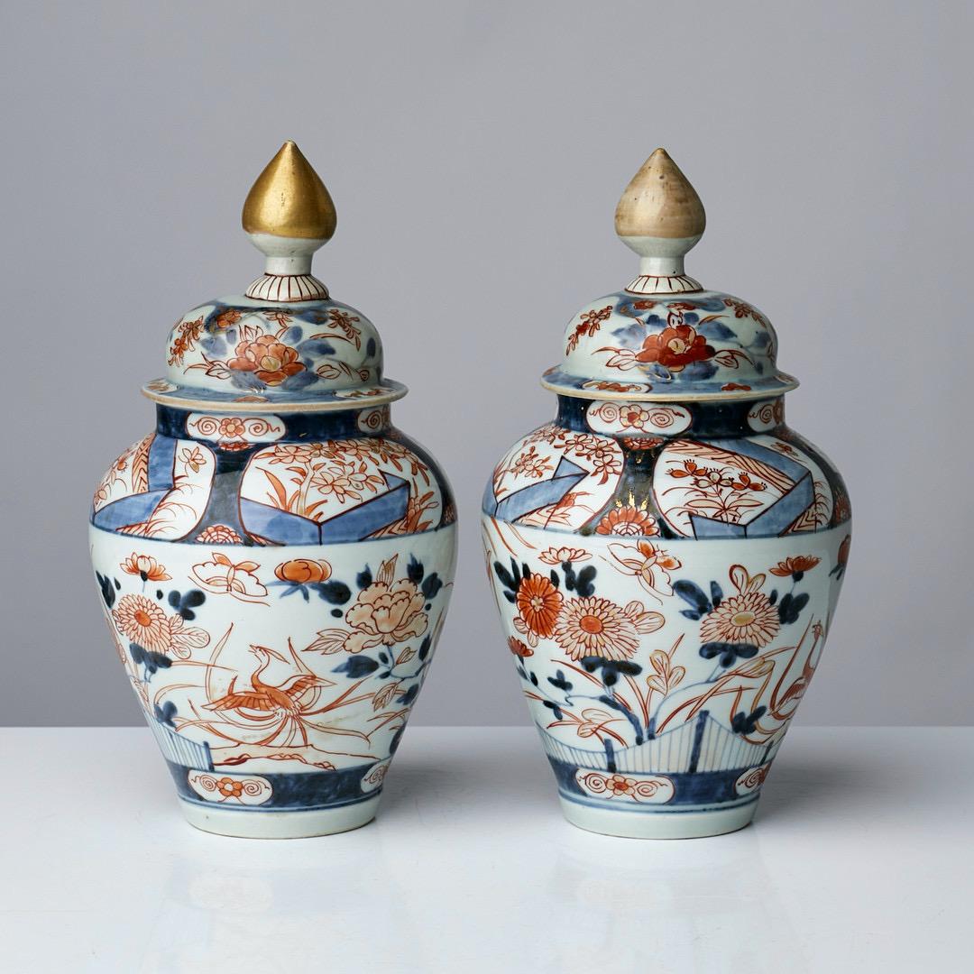 A fine pair of small 18th century Japanese imari urnes with lids.
