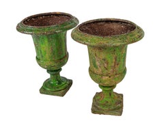 A pair of 18th century large green painted urns.