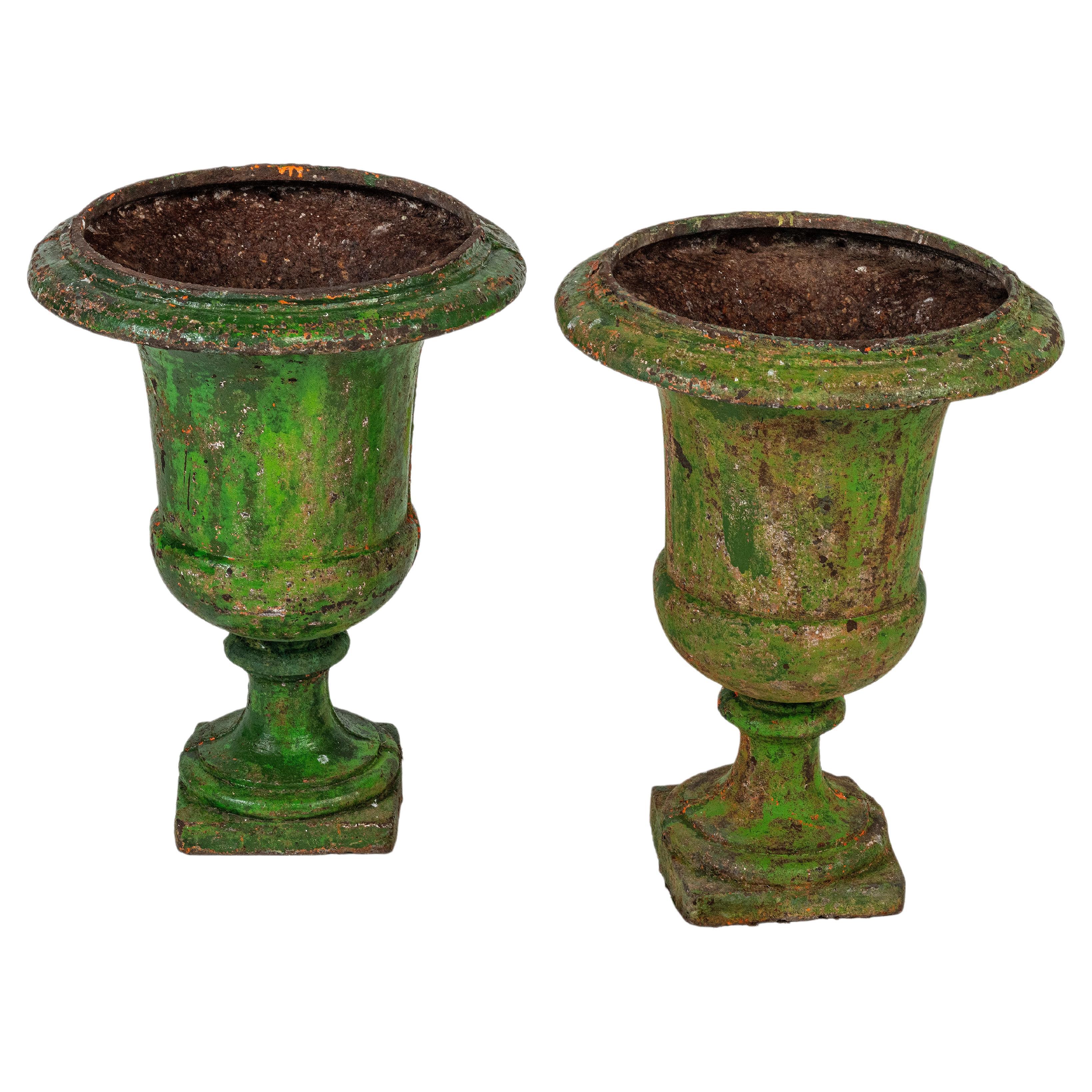 A pair of 18th century large green painted urns.