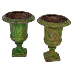 A pair of 18th century large green painted urns.