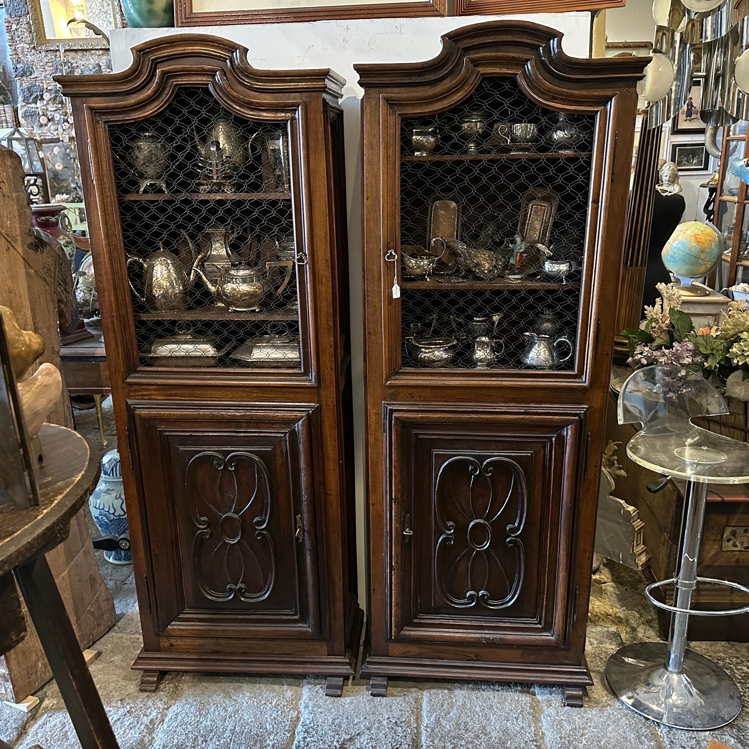 These High Hand-carved Walnut Wood Italian Credenzas arecexquisite examples of craftsmanship from that era. In the Late Louis XVI style, in Italian called Maria Antonietta style, the two pieces of furniture are characterized by elegance, refinement,