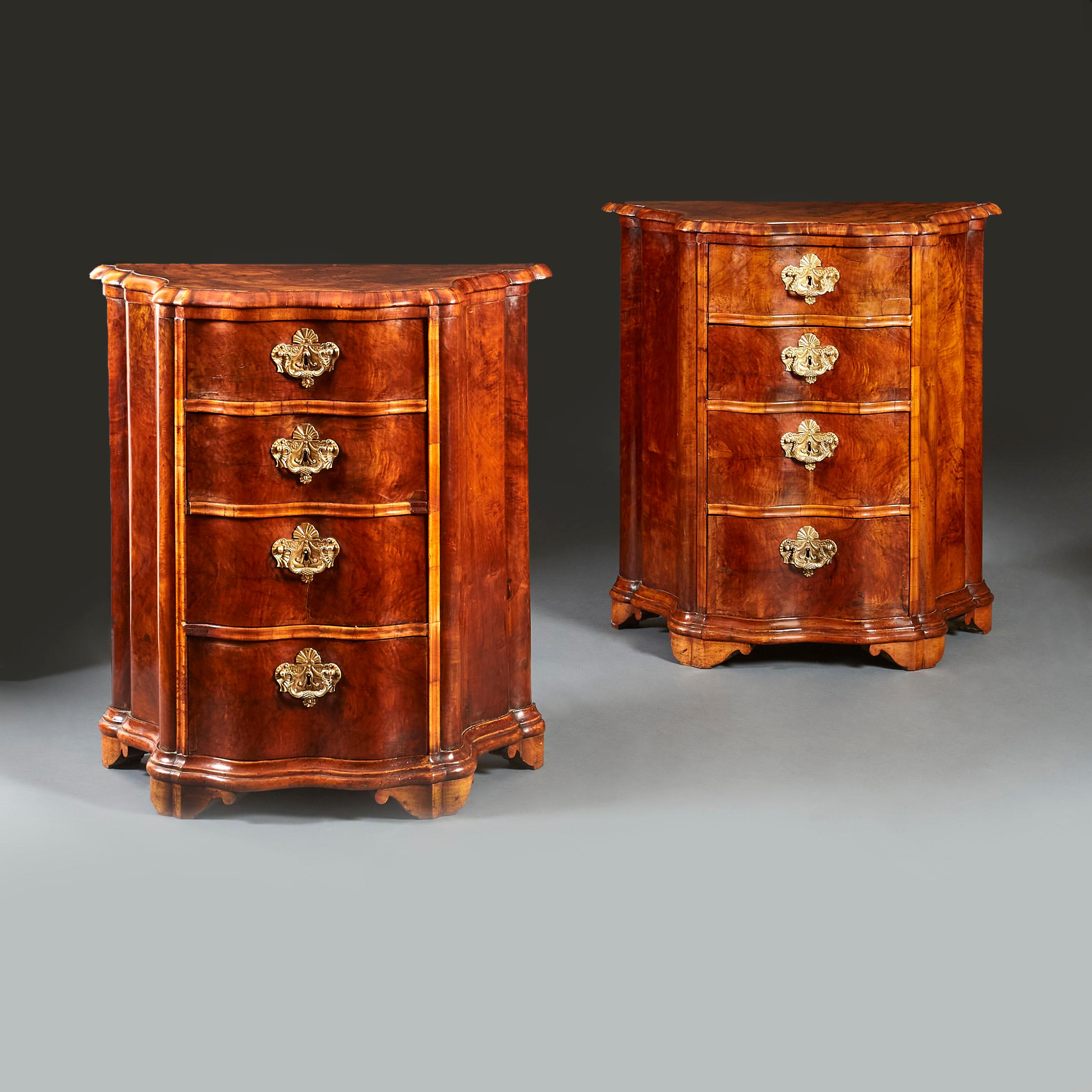 A fine pair of late eighteenth century burr walnut Italian bedside commodes, with shaped serpentine fronts, retaining the original fire gilt handles and escutcheons, raised on shaped bracket feet.