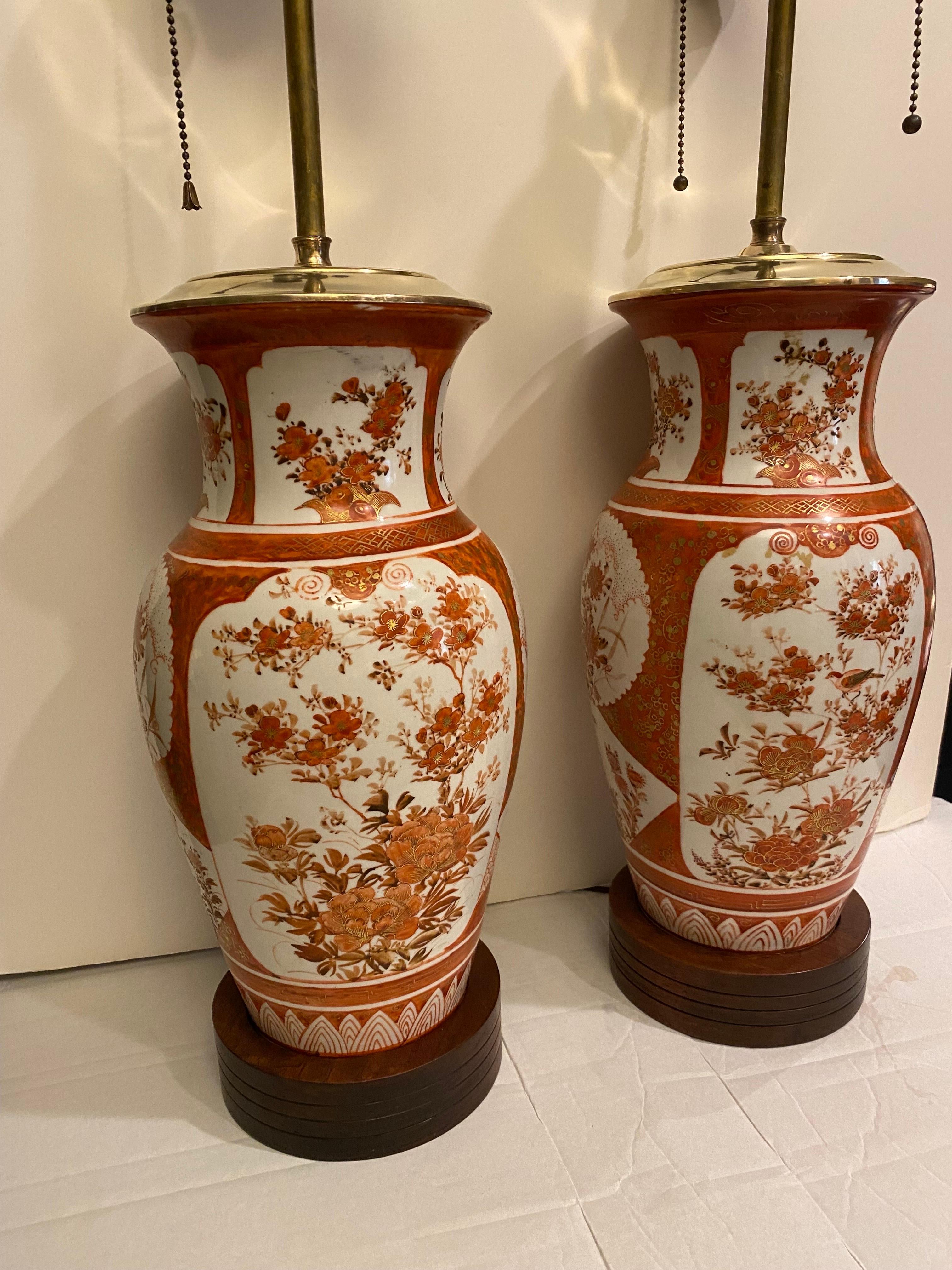 A classic pair of Iron red Kutani porcelain lamps.  The Meiji Period circa 1880 vases, now as lamps.  These elegant fine Japanese porcelain vases we converted to lamps in the early part of the 20th Century, around 1920, Measuring 30 inches high, and
