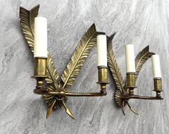 A pair of 1920s brass wall sconces in the empire style with feather design
