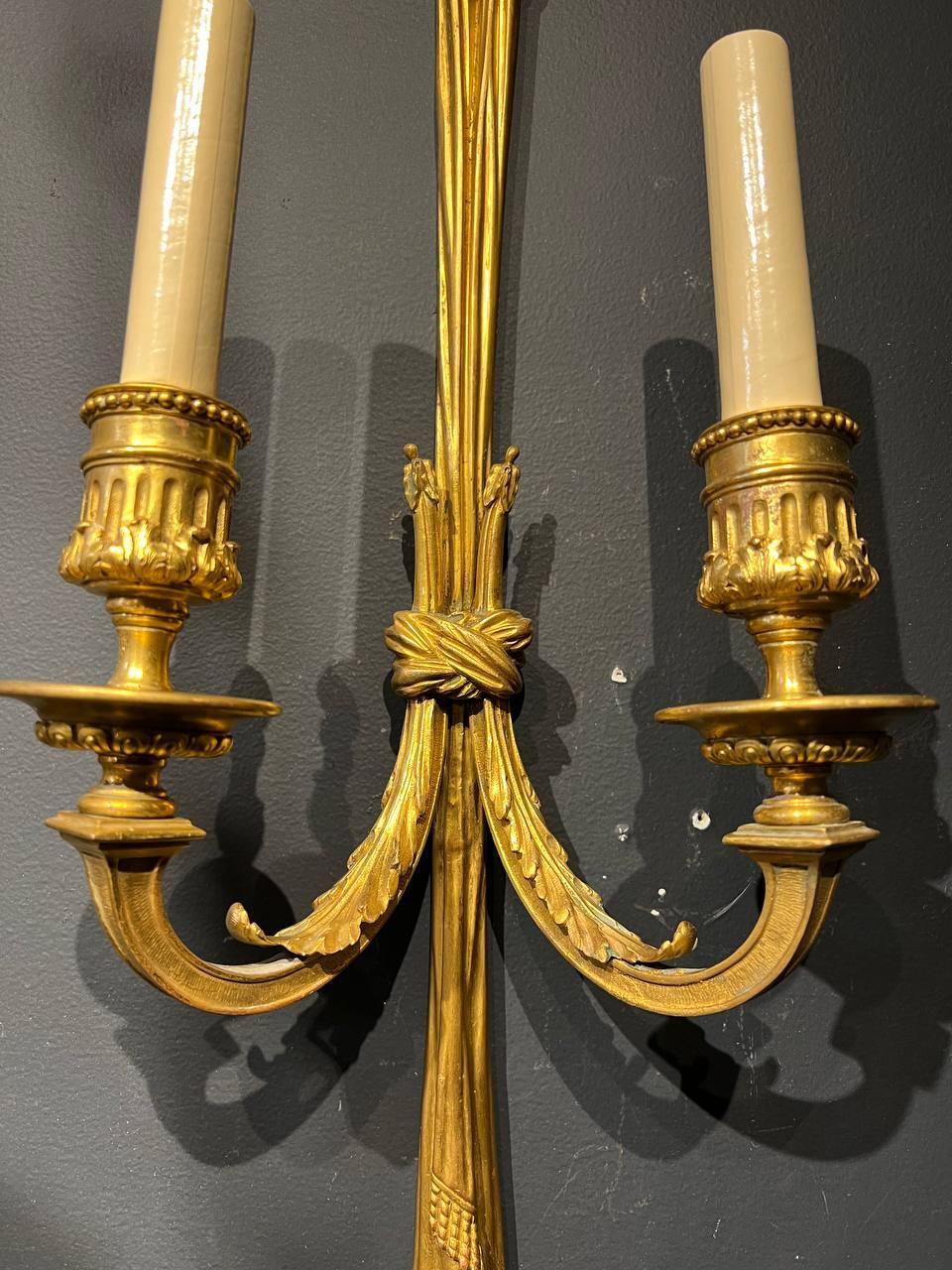 A pair of circa 1930’s Caldwell double light French style sconces original finish. Lamp shade is not included. In very good vintage condition, with original condition unaltered. 

Up to 120V (US Standard)
Hardwired

Dealer: G302YP 

