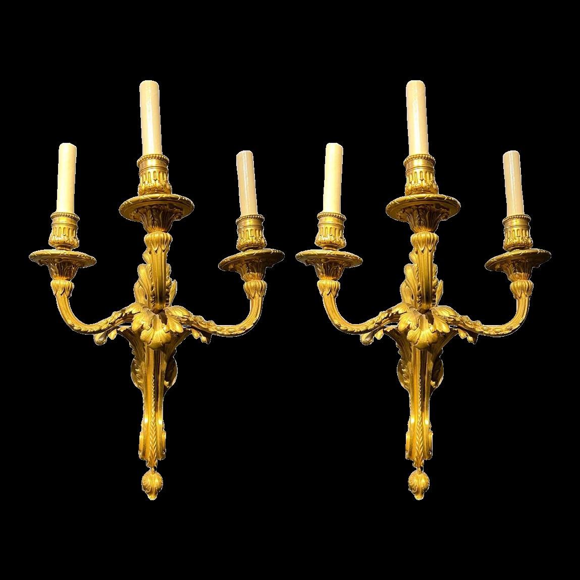 A pair of circa 1920's large gilt bronze 3 lights sconces with Acanthus leaves design.
