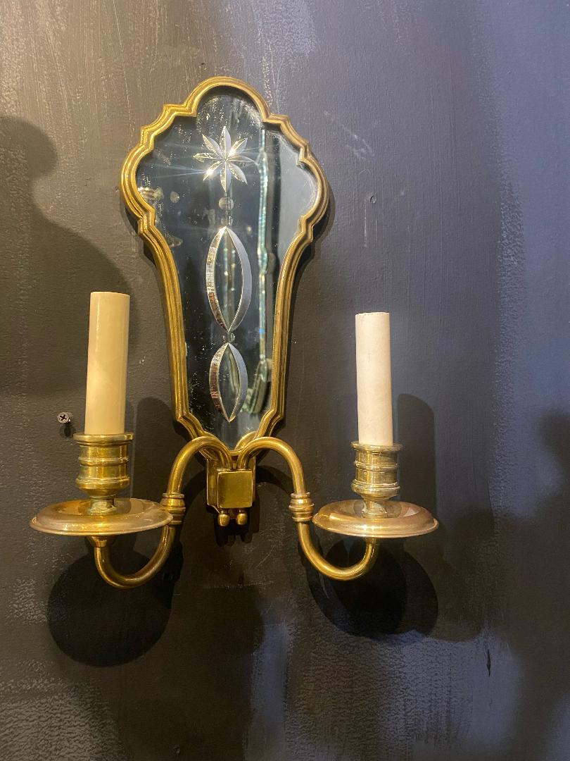 A pair of circa 1920's Caldwell gilt bronze sconces with etched mirrored backplate.