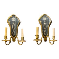 A pair of 1920's Caldwell sconces with etched mirrored backplate