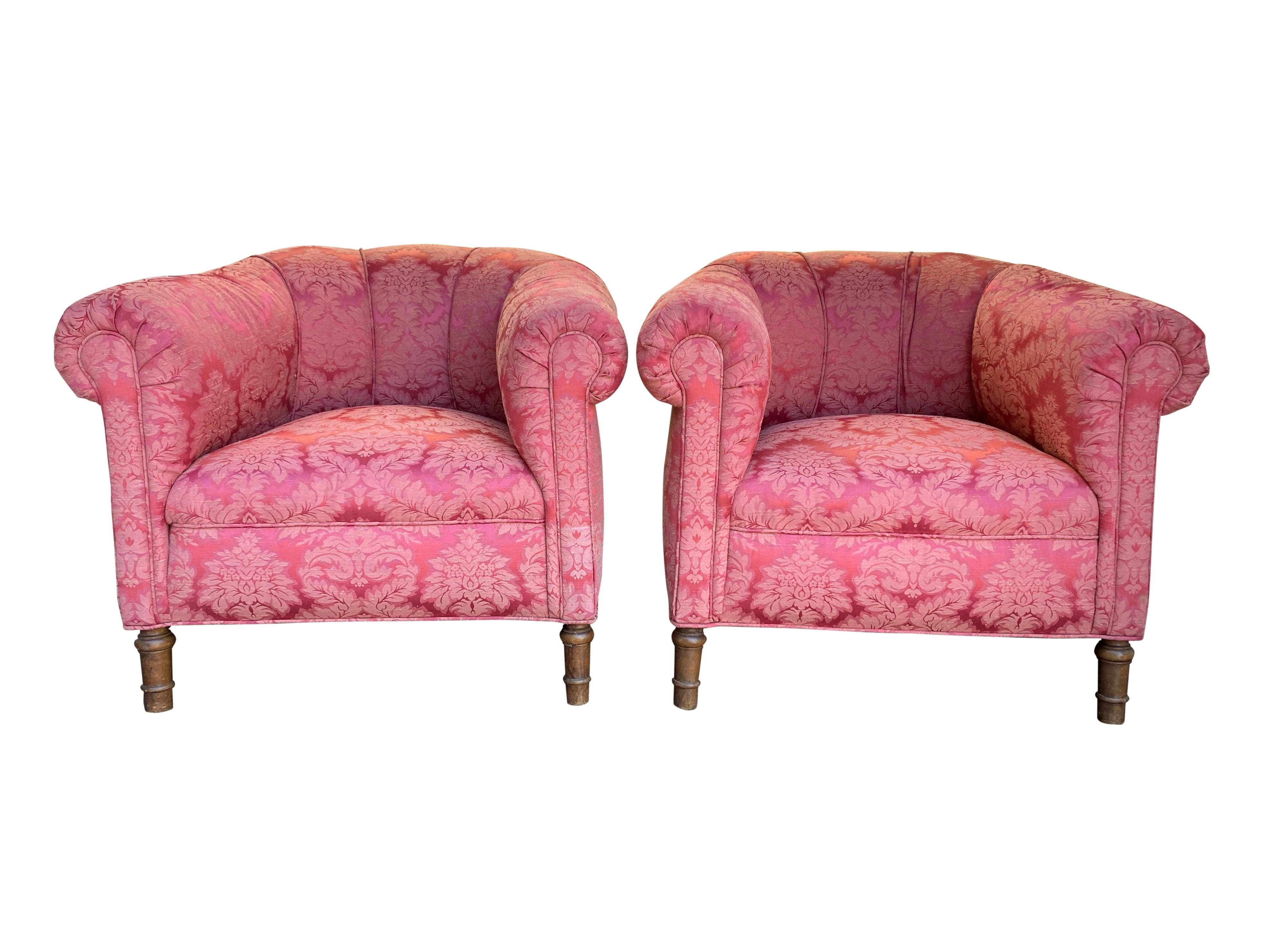 A pair of 1920s club chairs in damask floral design. This ornate, cute but grand comfortable set is strong and playful at the same time. The webbed back gives perfect support for the sitter. The thick seat with cushion creates a nice balance between