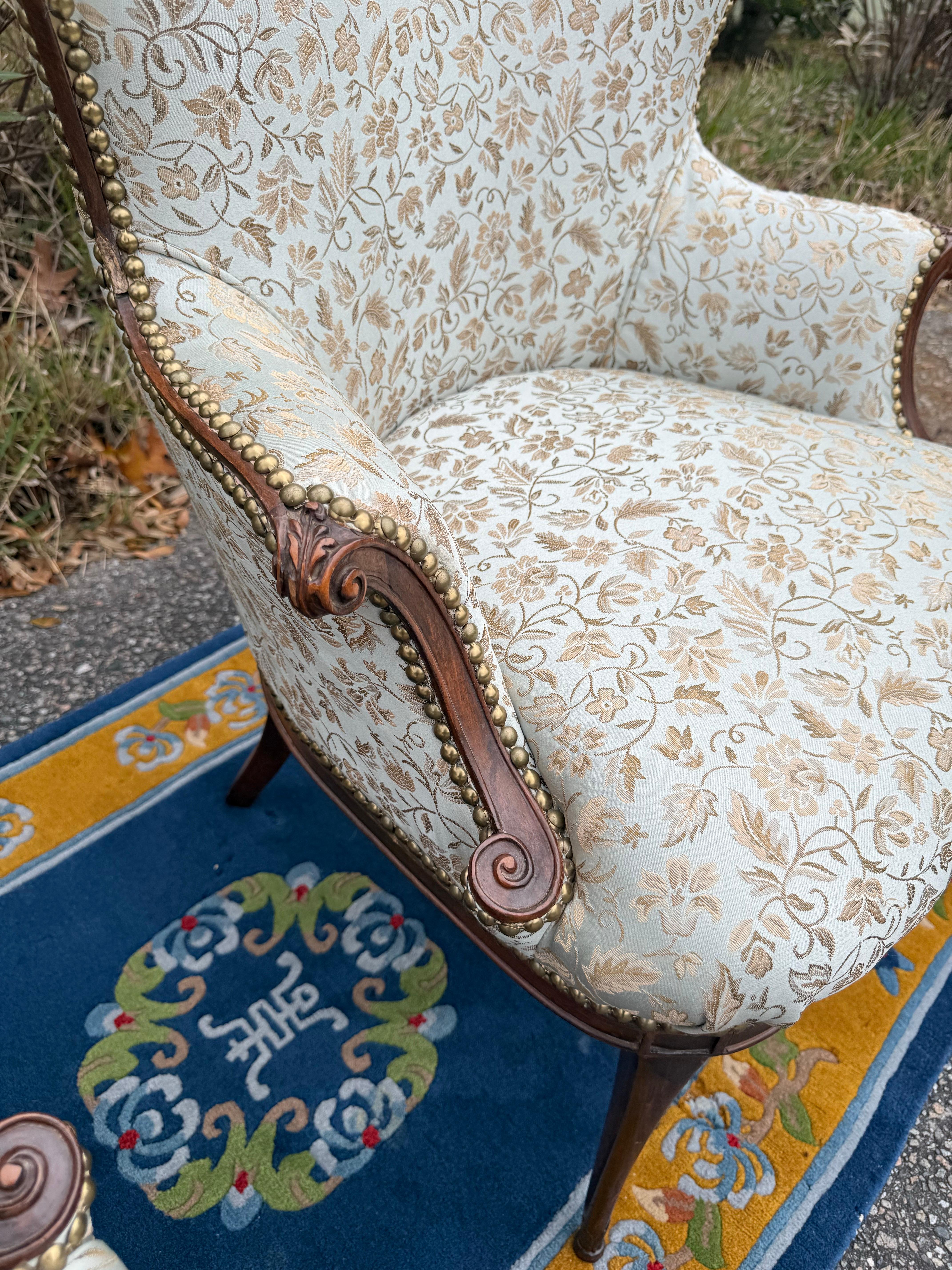 Antique Butterfly Wingback Armchairs with French  blue Upholstery. These charming antique armchairs have two curved armrests with a lovely scroll on both ends, as well as a heart-shaped, butterfly wingbacks. It has sabre legs that have a leafy