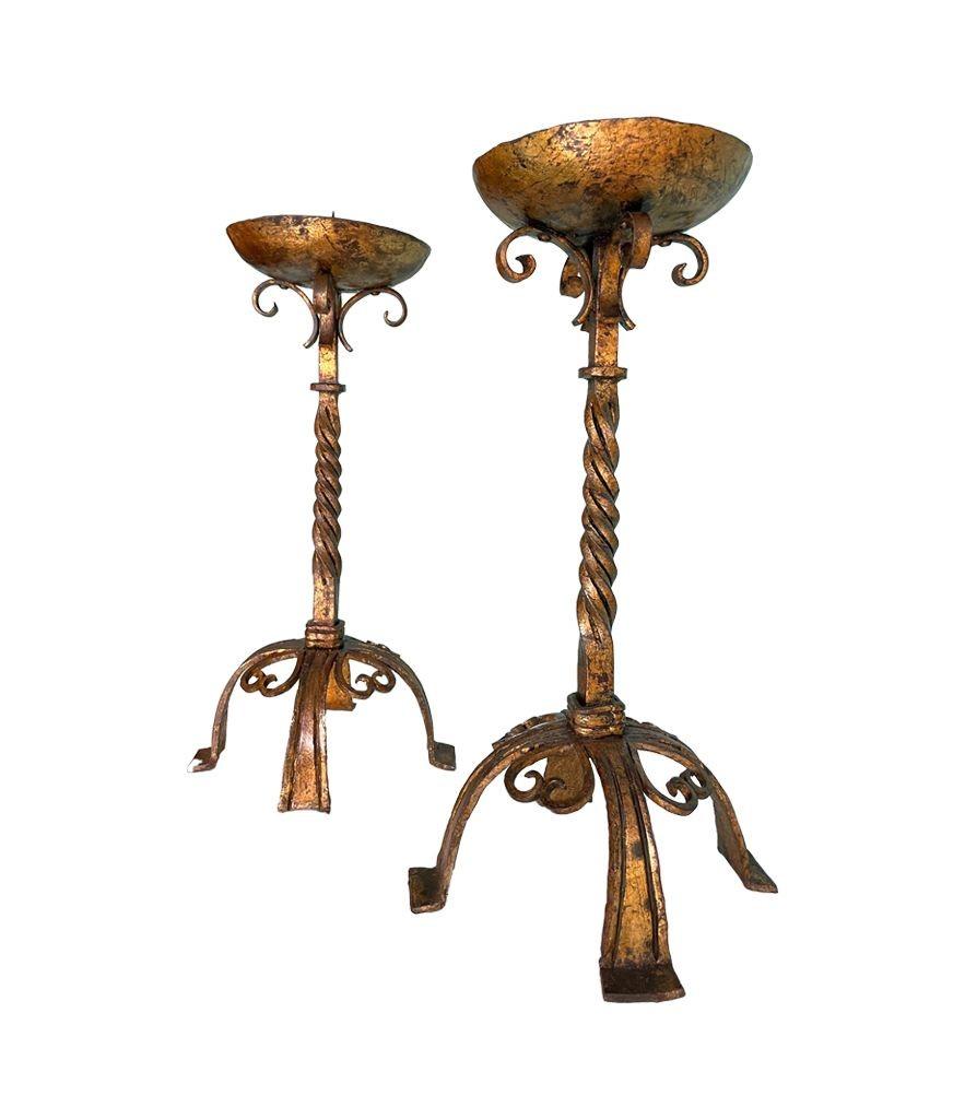 Arts and Crafts A pair of 1920s Spanish ecclesiastical gilt wrought iron candle sticks For Sale