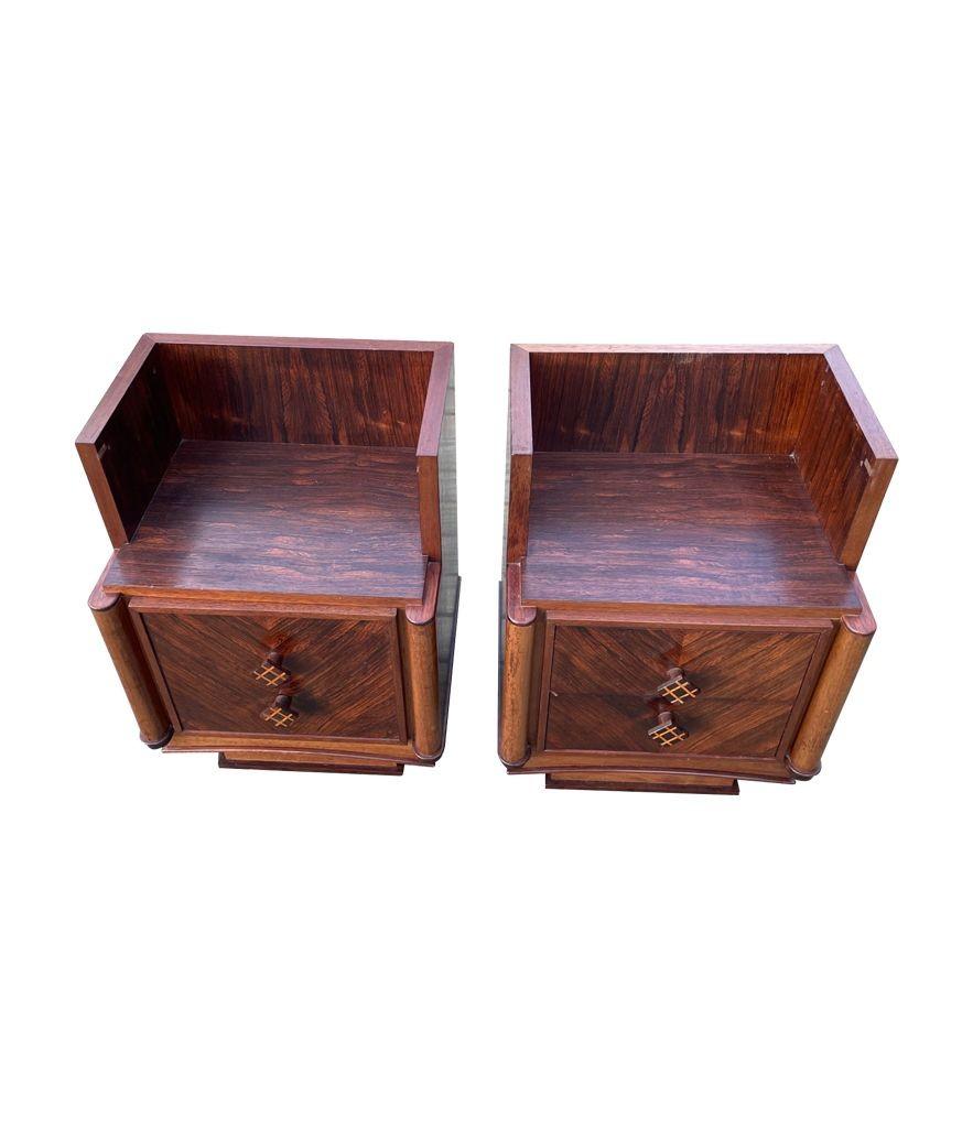 A pair of 1930s Art Deco walnut bedside table, one with a door the other with 2 drawers. Each with two diamond shaped knobs, with inlay detail. Both with a lovely orignal rich patina.