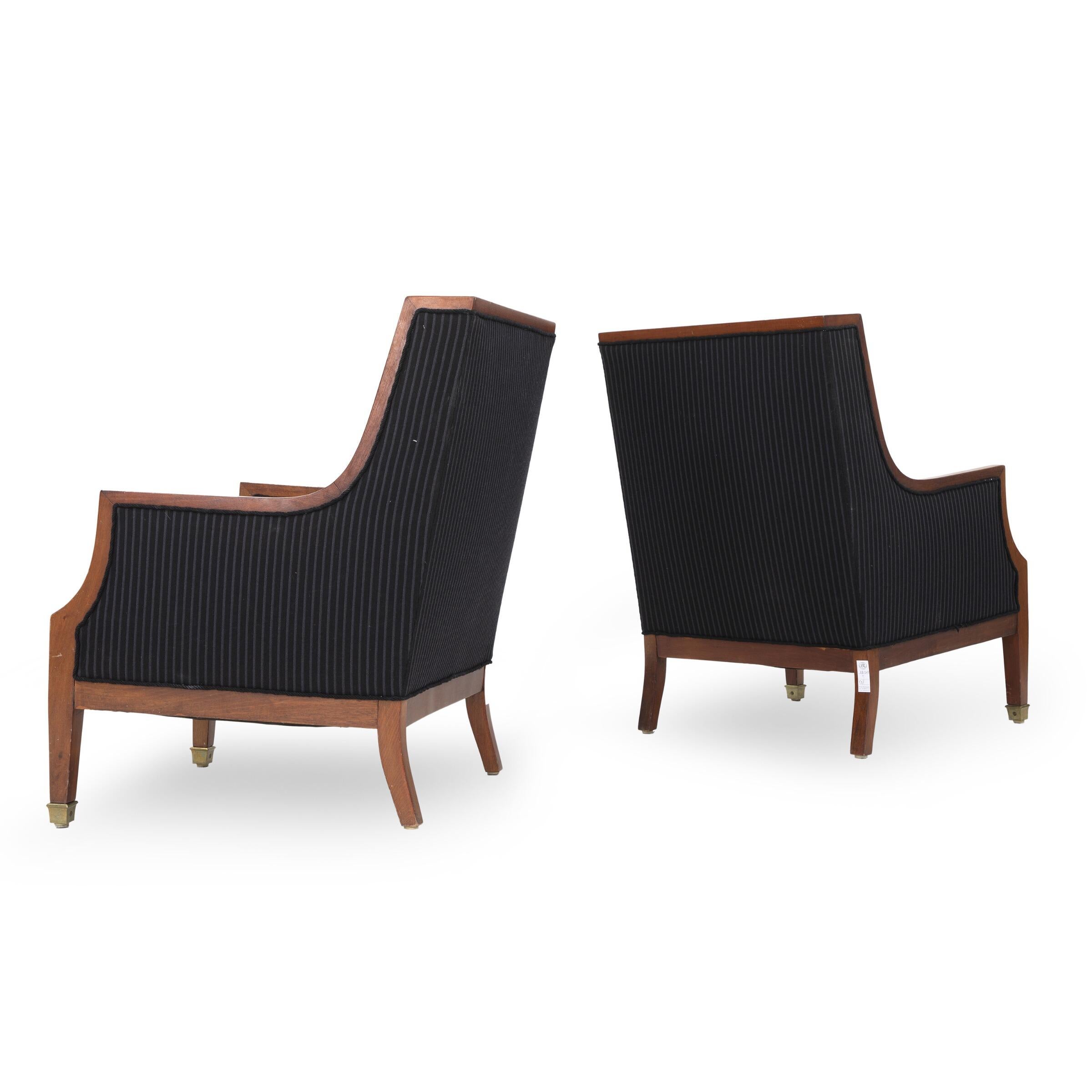 A pair of Danish armchairs of mahogany, front legs with brass shoes. Seat and back upholstered with black striped wool, 1930s-1940s.