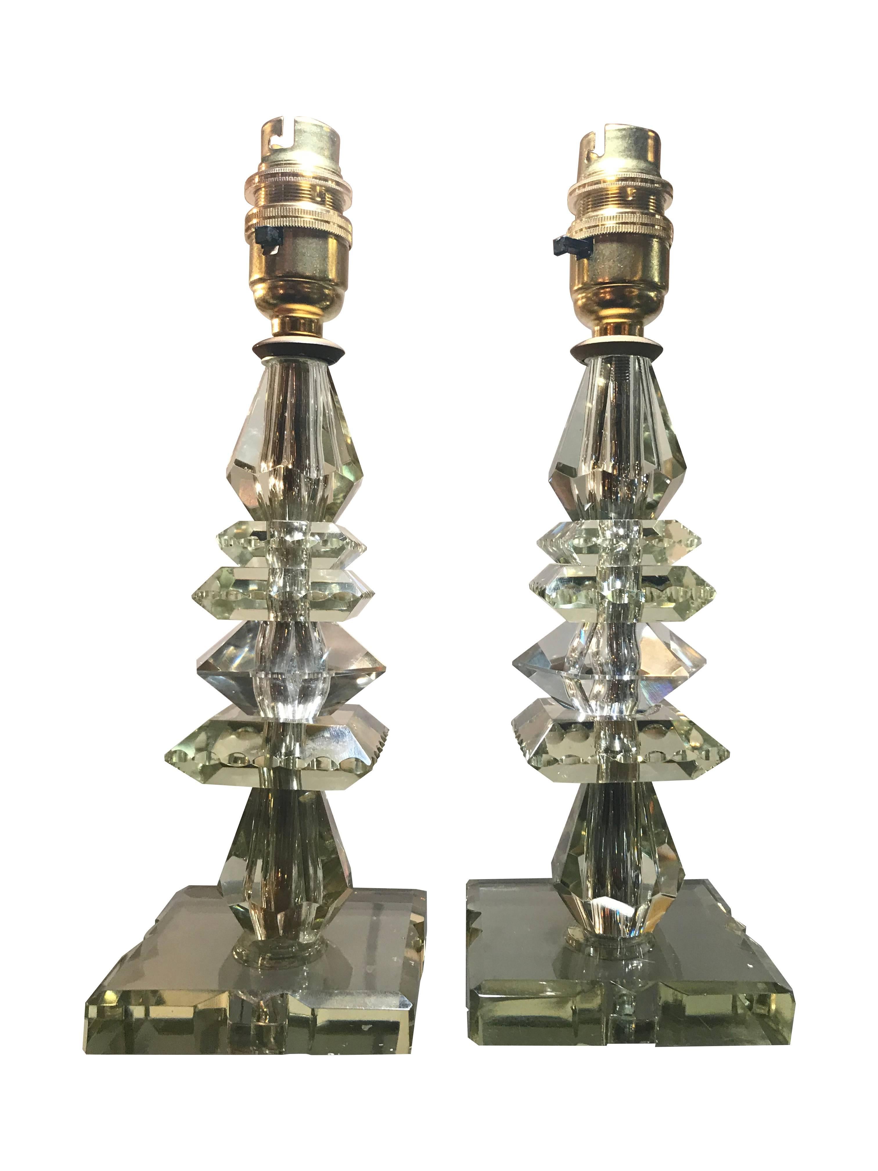 A pair of 1930s French green crystal glass lamps with brass fittings, re-wired and pat tested with antique silver cord flex.