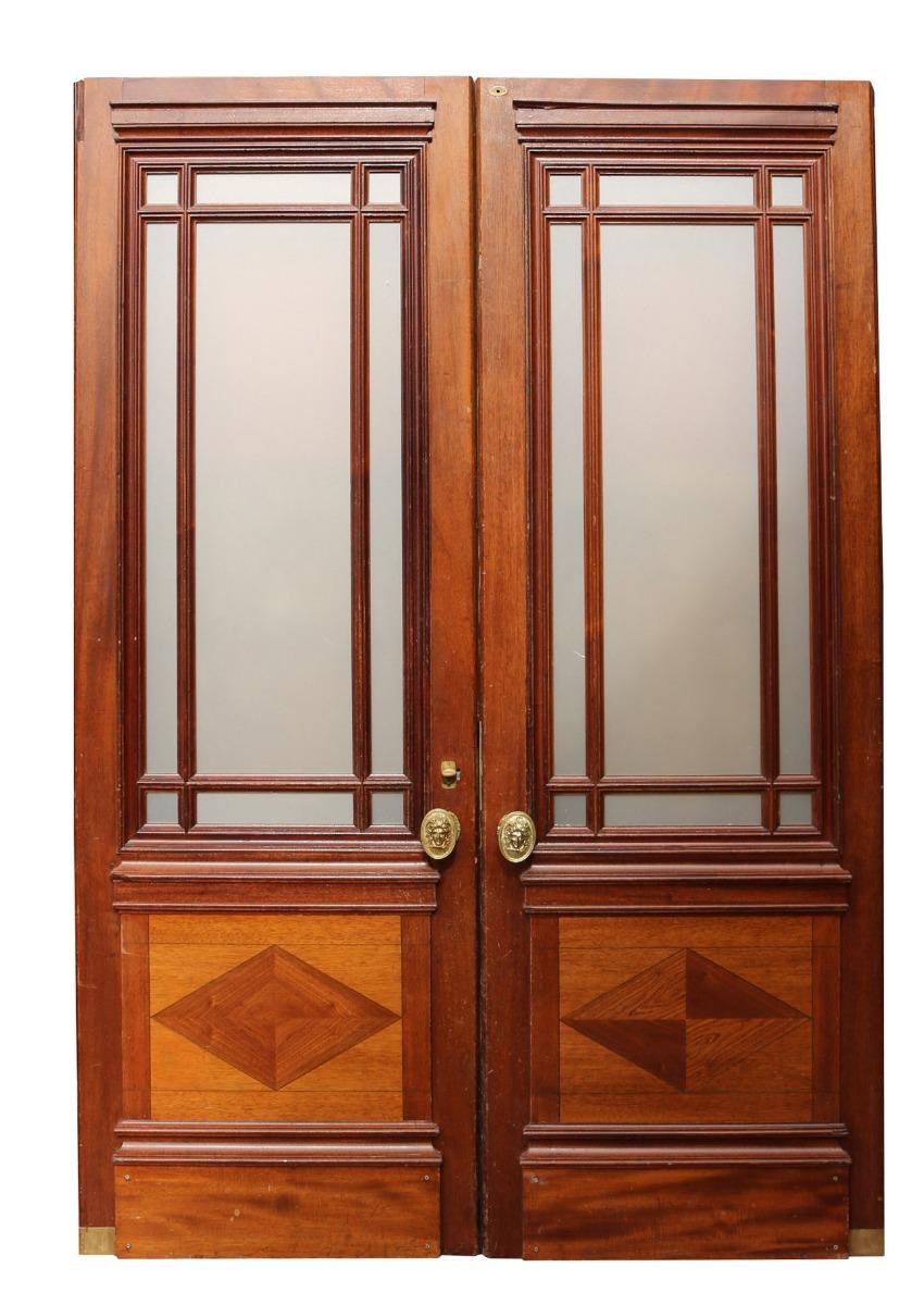 These substantial doors are of solid mahogany construction, are fully glazed with opaque glass and are currently configured as swing doors. Formally used in a London gallery.
