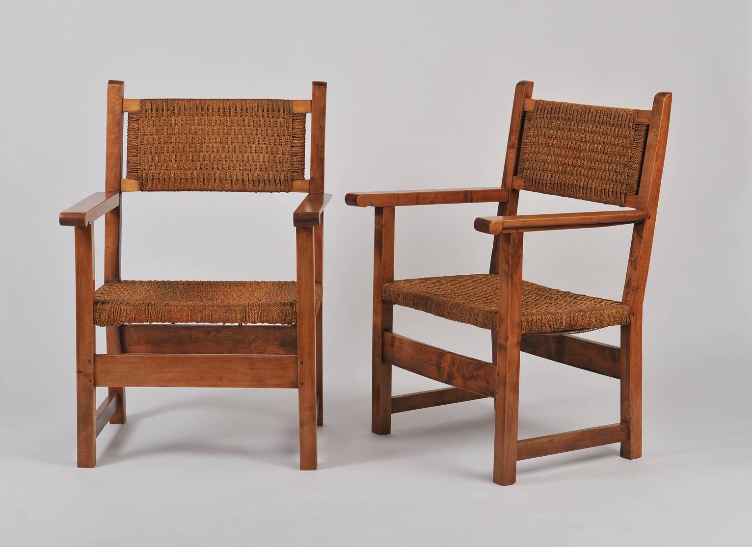 A pair of solid walnut and woven sea grass armchairs
Sweden, circa 1935.