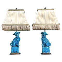A pair of 1950s ceramic foo dog lamps on decorative brass base