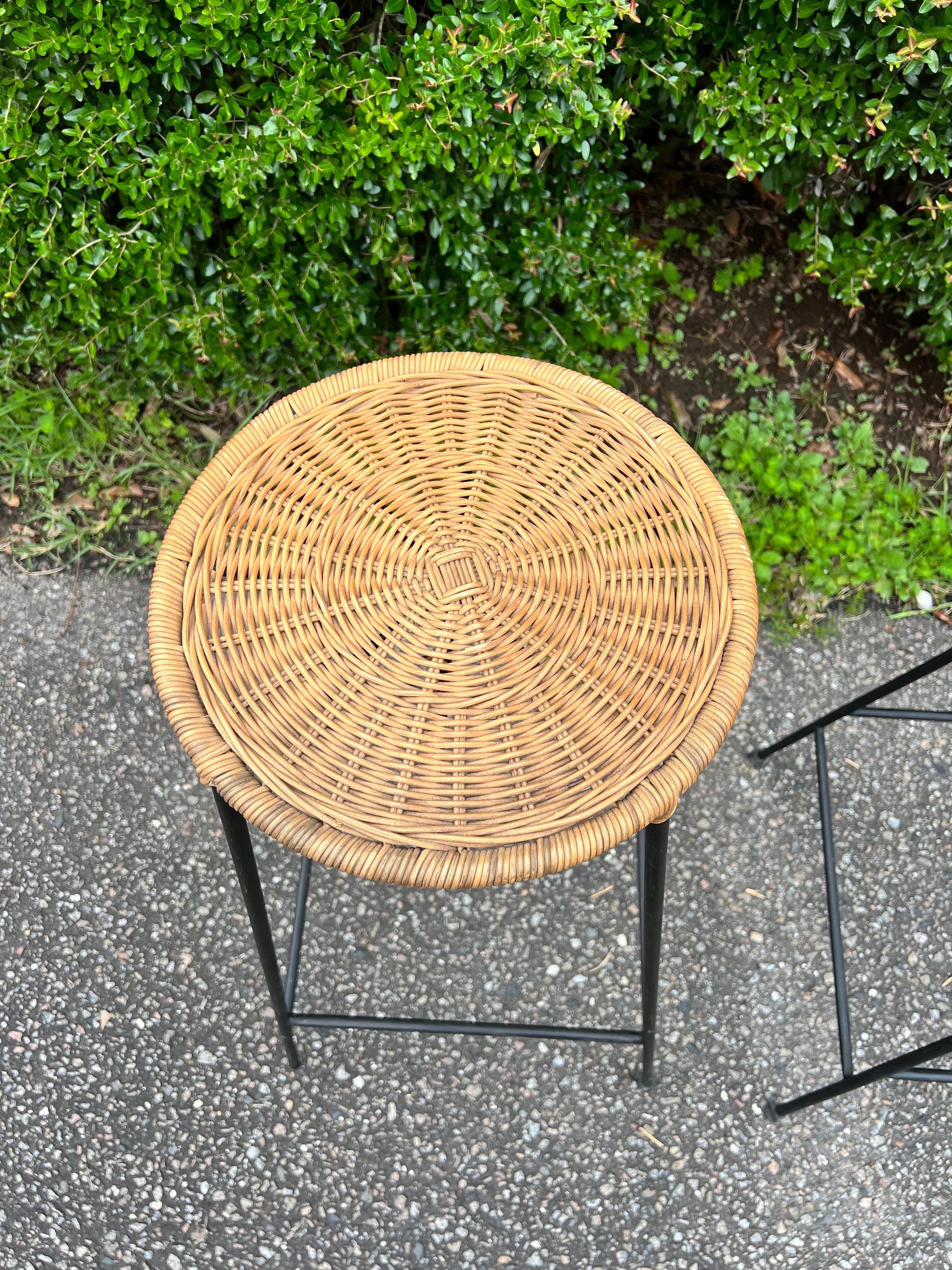 Often misattributed to Arthur umanoff, these fabulous bar stools were in production from the 1950’s-1960’s by The Fong Brothers Company.    The seats are made of a woven rattan with black metal legs.  These are perfect for your mid-century modern