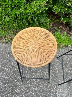 A pair of 1950’s Danny Ho Fong Style Counter Height Bar Stools in iron and wicke
