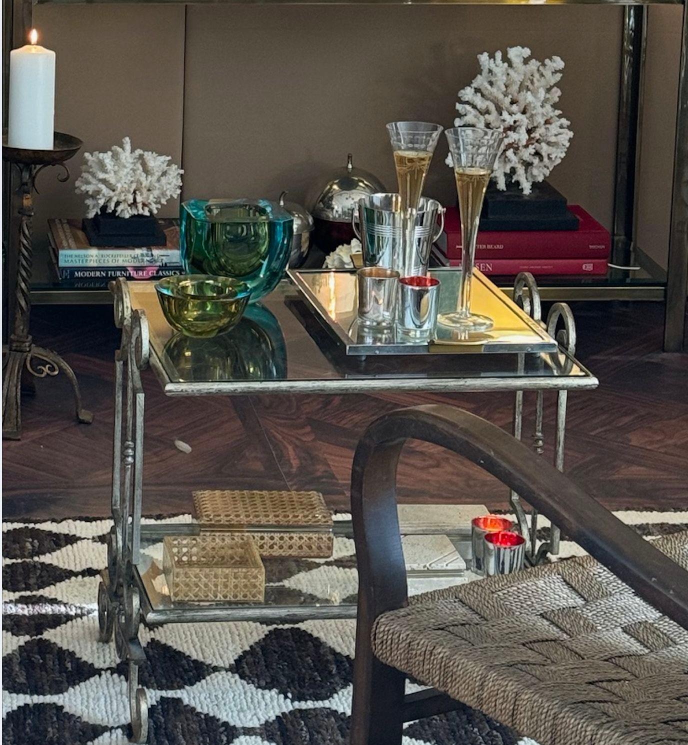 A lovely pair of 1950s gilt wrought iron French side tables, with two glass shelves on each, both in light white gilt finish.