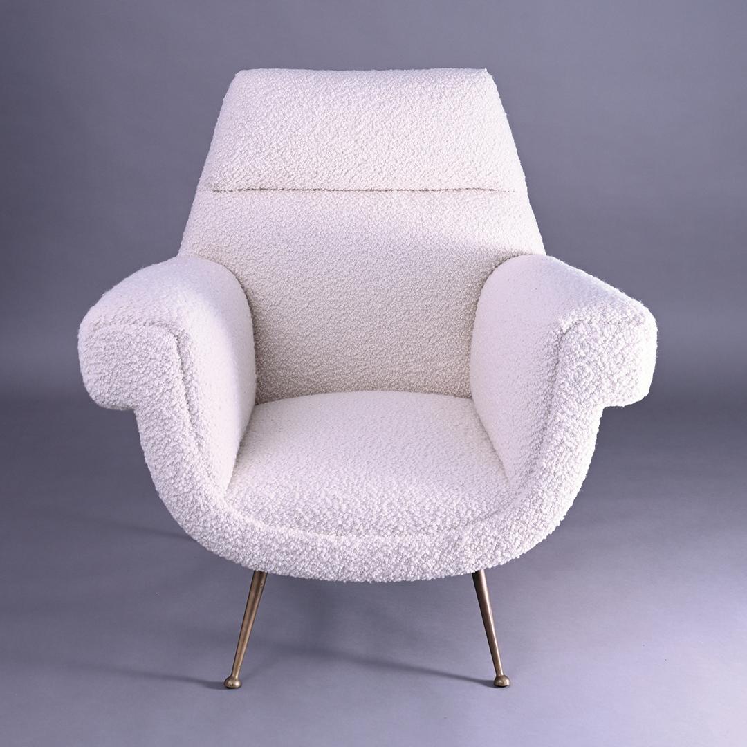 A stunning pair of 1950s Italian armchairs by Gigi Radice for Minotti. These iconic chairs have been sympathetically restored and are newly upholstered in luxurious Zinc bouclé and the brass splayed legs have just the right amount of