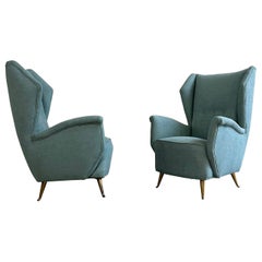 A pair of 1950s italian light-blue armchairs by Isa Ponte San Pietro brass feet