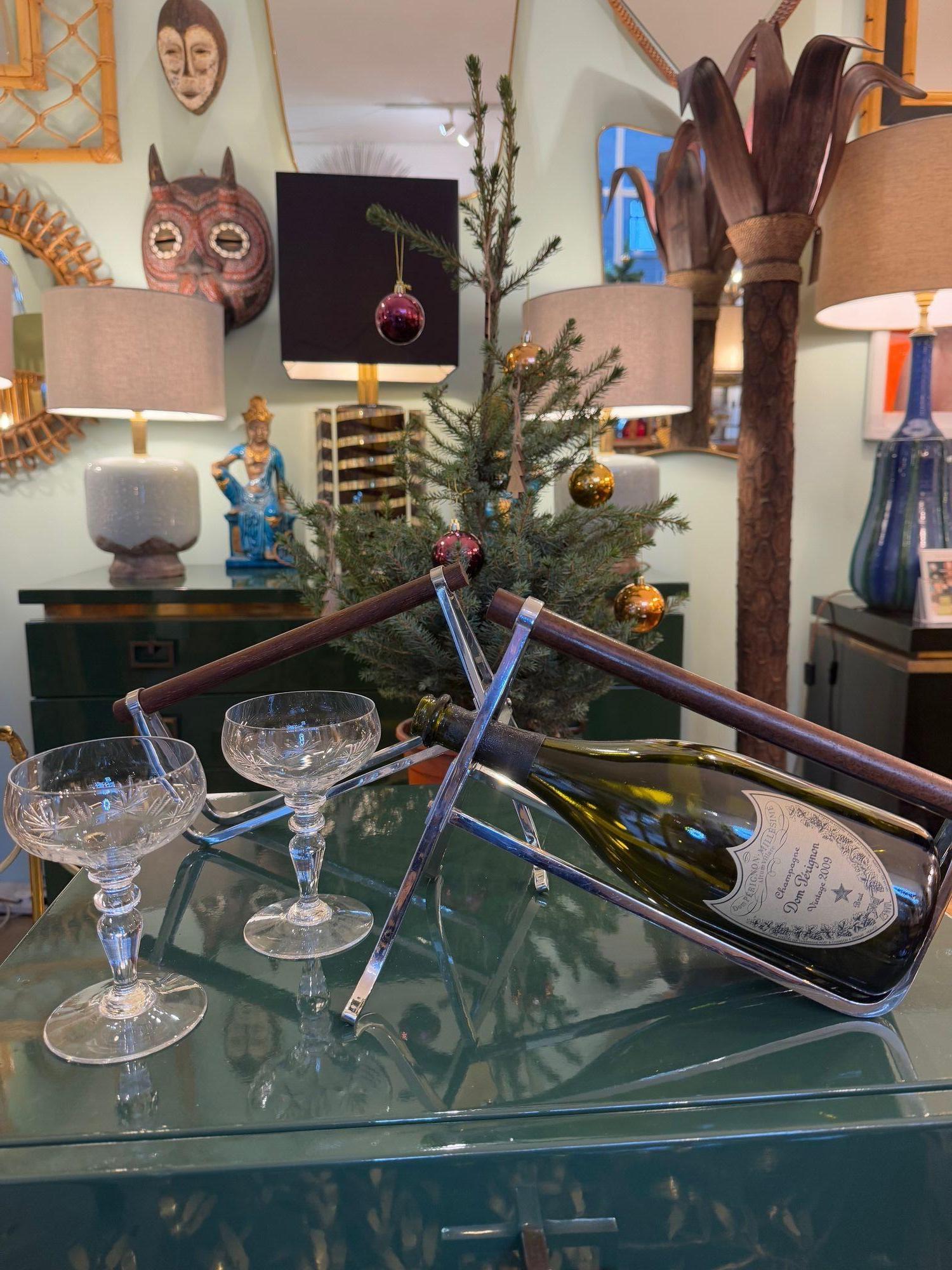 A pair of 1950s Jaques Adnet chrome and walnut bottle holders for Christolfe.