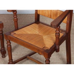 A pair of 1950s oak wicker armchairs