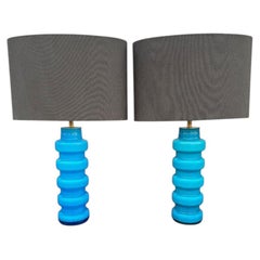 A pair of 1960s Danish glass lamps by Holmegaard with brass fittings