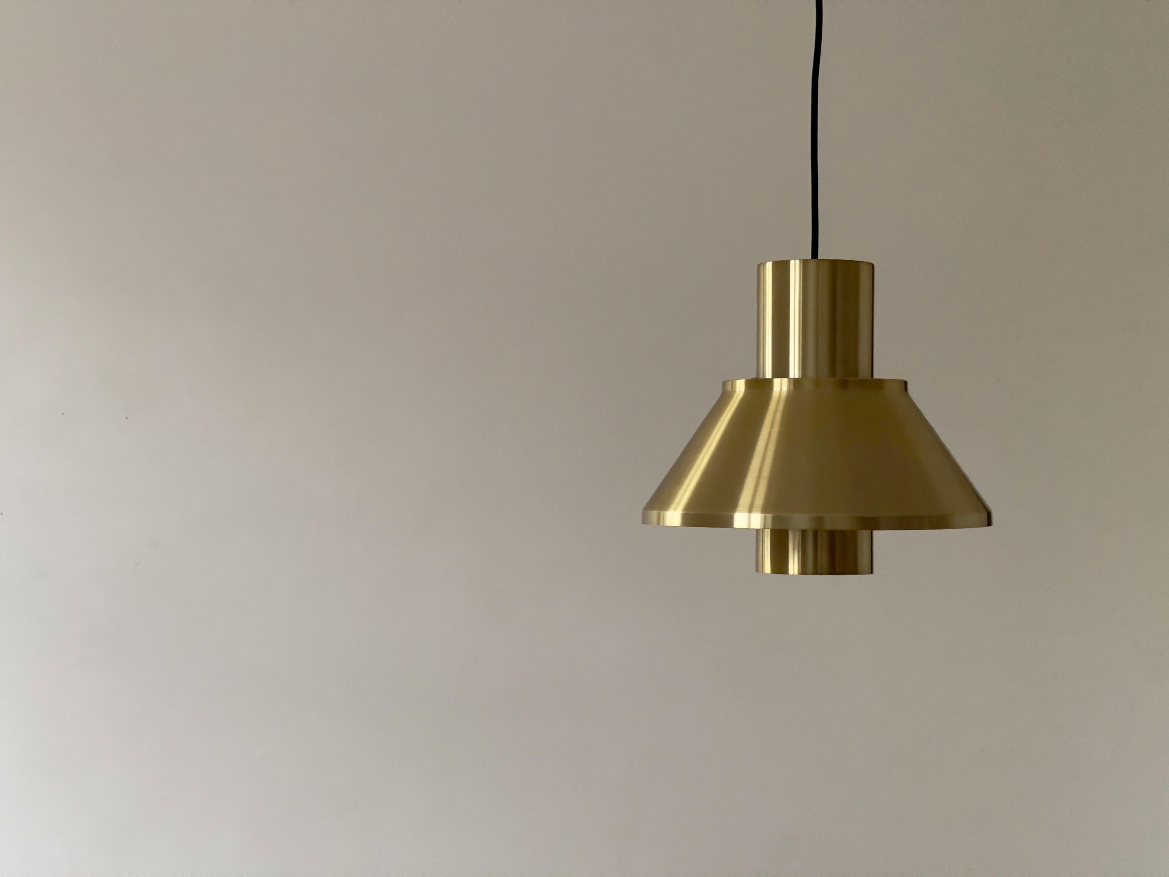 A pair of original 'Life' pendants lamps by Jo Hammerborg for Fog & Mørup Denmark. They are beautiful medium sized pendants emitting a direct light and soft warm illumination of the room. It has a aluminium shade with a brass colored coating. The