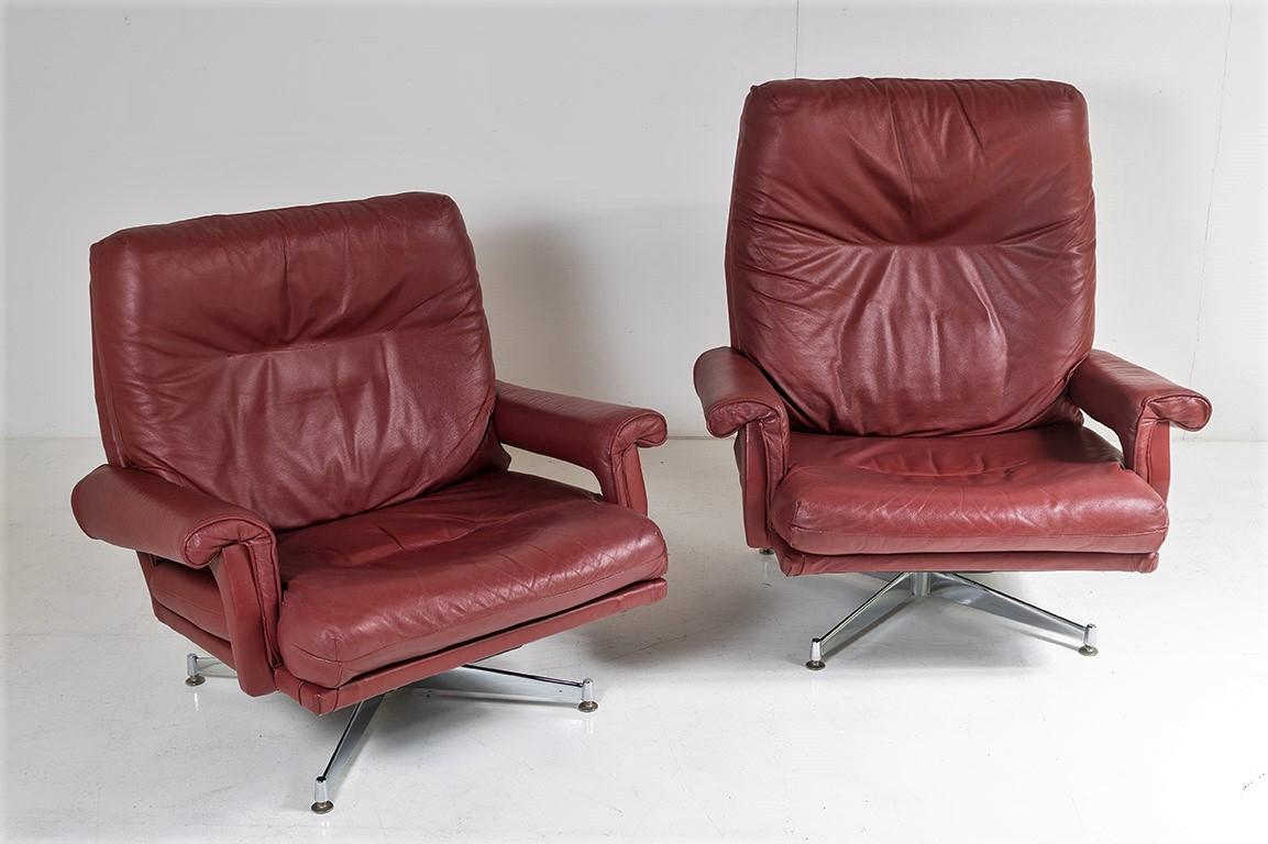 A pair of original, Howard Keith Leather swivel chairs in excellent condition.  In beautiful deep red wine / burgundy / maroon colour, the pair are a set with one low back and one high back chair.
This set boasts all its original chrome steel bases