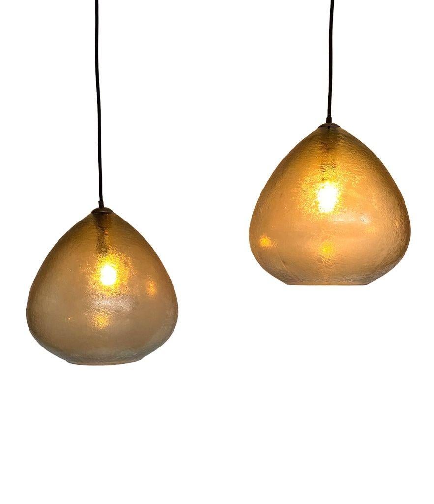 A pair of 1960s Murano glass ceiling lights by Luigi Caccia Dominioni for Azucena. The lights were commissioned for a hotel in Milan and have a wonderful teardrop shape with smoked textured Murano glass, each one is handmade. With orignal brass top