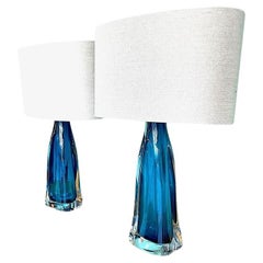 A pair of 1960s Orrefors hand blown turquoise glass and brass lamps