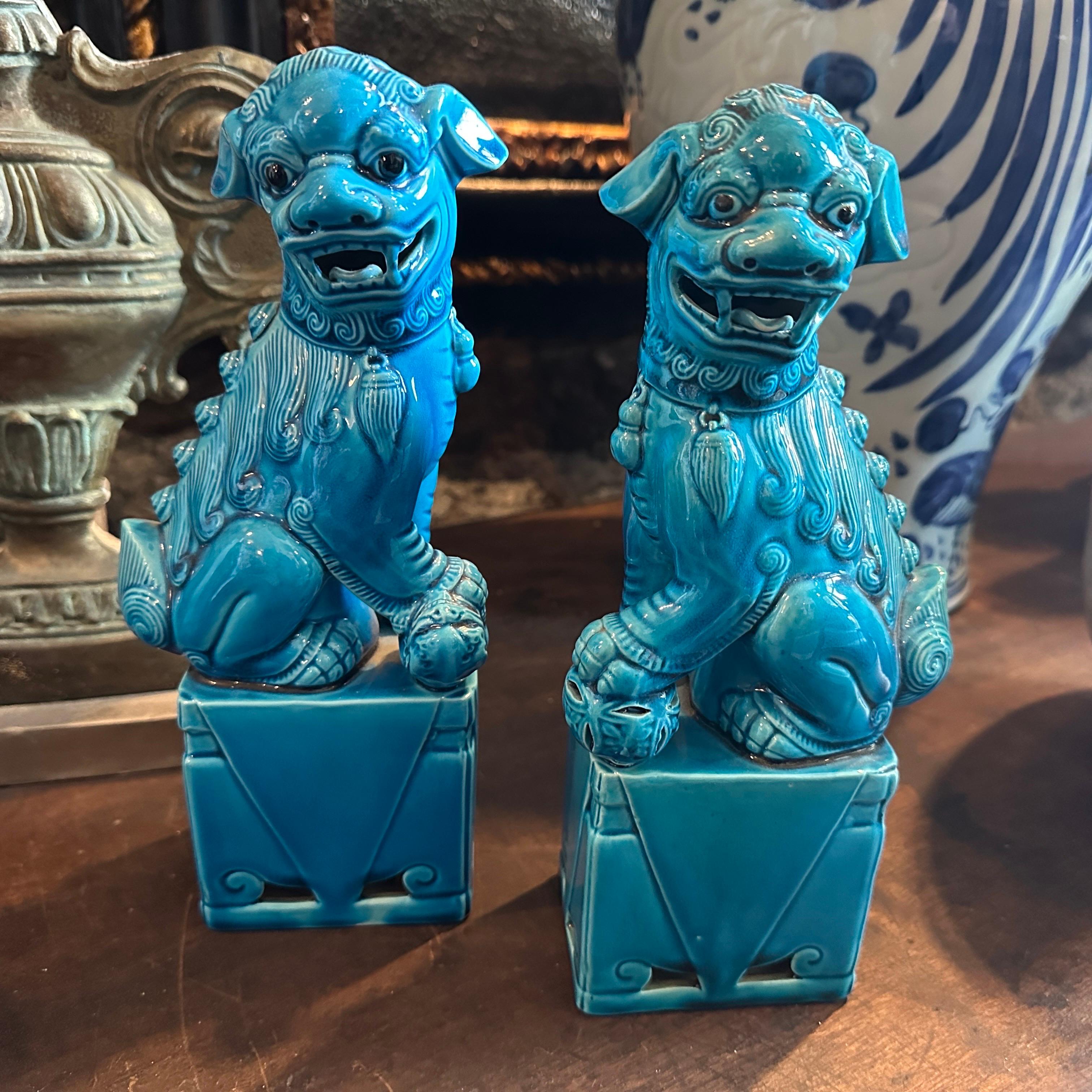 This pair of 1960s turquoise glazed ceramic Chinese Pho Dogs (also known as Foo Dogs or Fu Lions) are decorative guardian figures that reflect traditional Chinese symbolism and craftsmanship. These pieces combine cultural heritage with a striking