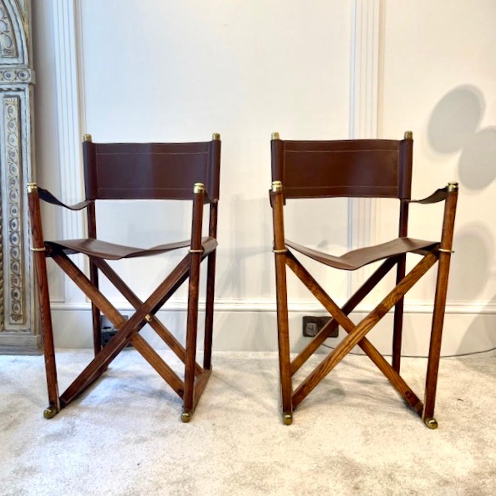 A fine pair of Almazan folding campaign chairs dating from the 1960s after the Mogens Koch Mk-16 Safari chair which were originally designed in 1932.
Beautifully detailed with hand-stitched brown saddle leather for the back, arms and seat, finished