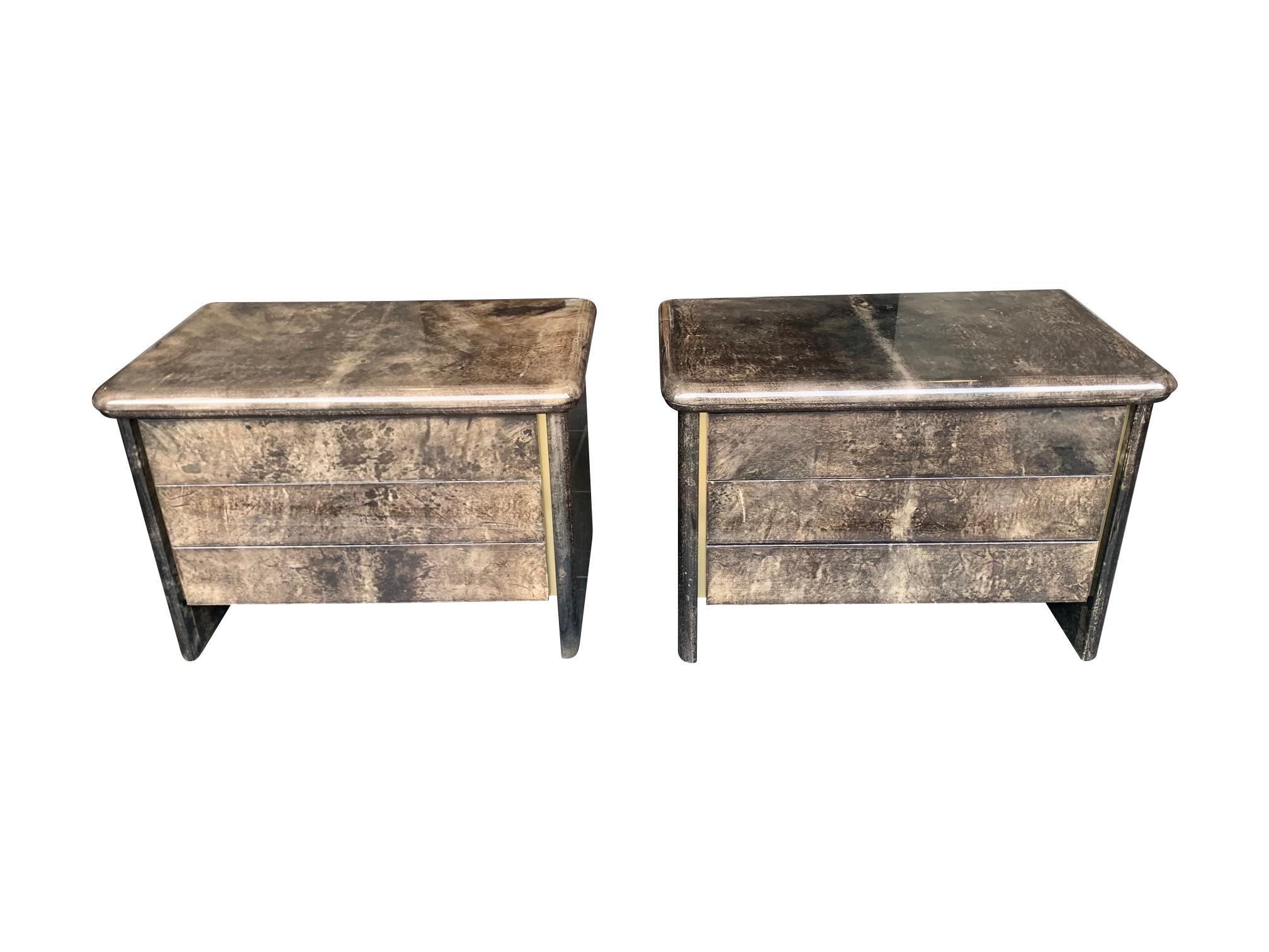 A lovely pair of 1970s grey lacquered goatskin bedside cabinets in the style of Aldo Tura.
Each cabinet has three drawers all with turquoise coloured solid wooden interiors. The quality and condition of the cabinets is very good as these came from