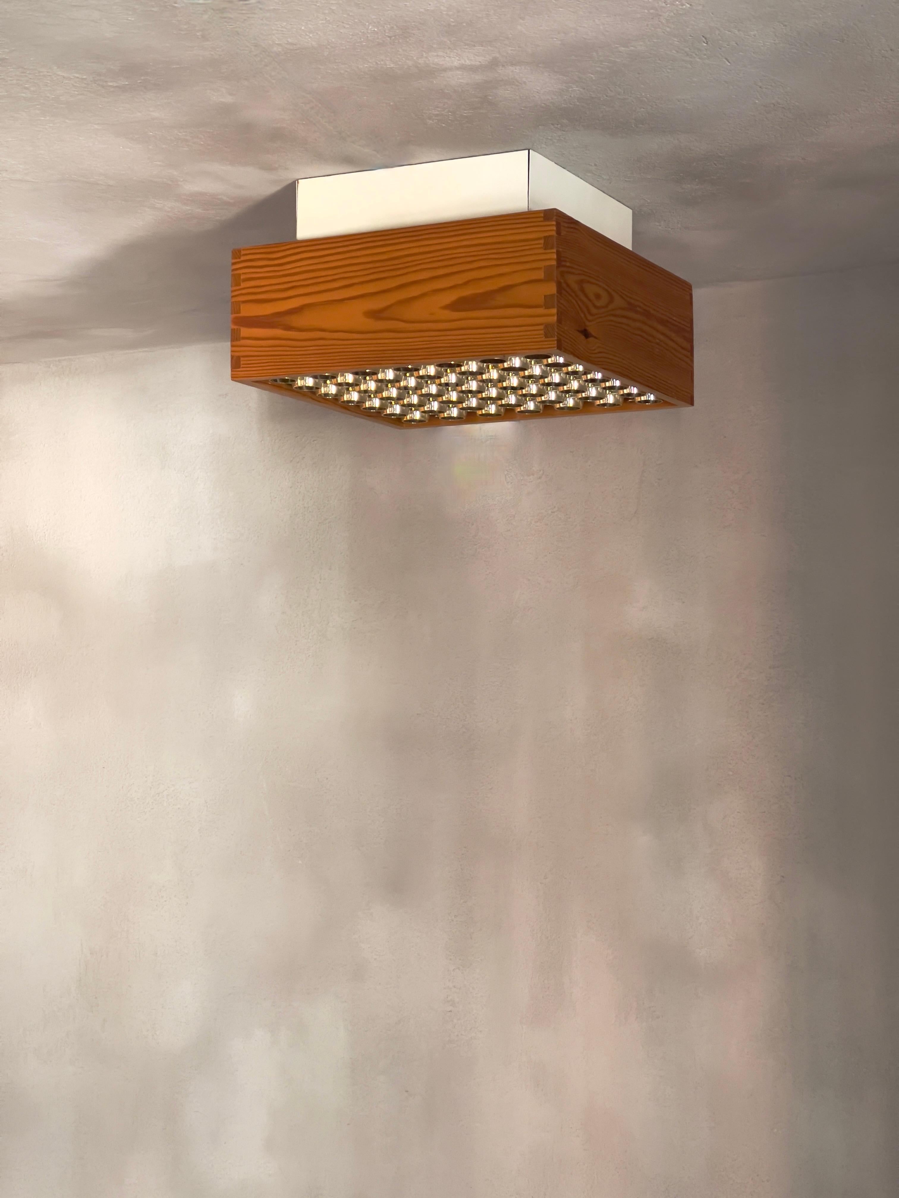 This pair (2 lamps) of 1970s Danish ceiling lights exemplifies the exceptional quality and minimalist design philosophy characteristic of Scandinavian mid-century modernism. Crafted with warm, patinated pine and acrylic diffusers, these ceiling
