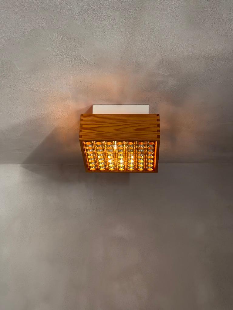 Scandinavian Modern A pair of 1970s danish ceiling lights in patinated finger-jointed pine. (2)