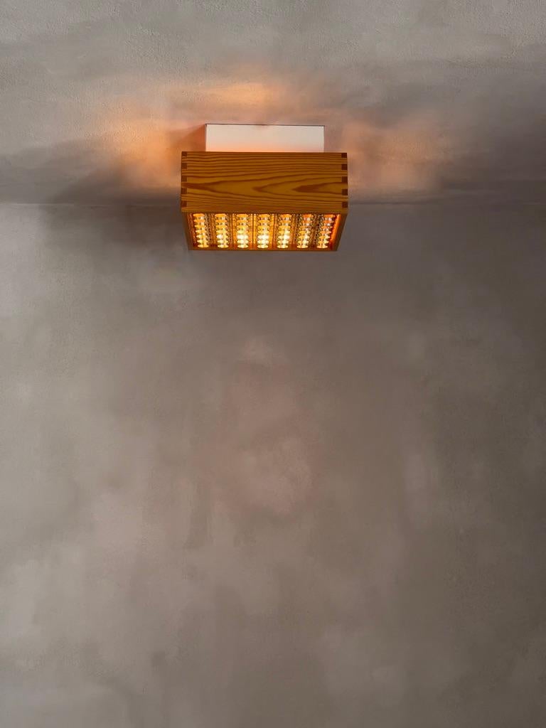 Acrylic A pair of 1970s danish ceiling lights in patinated finger-jointed pine. (2)