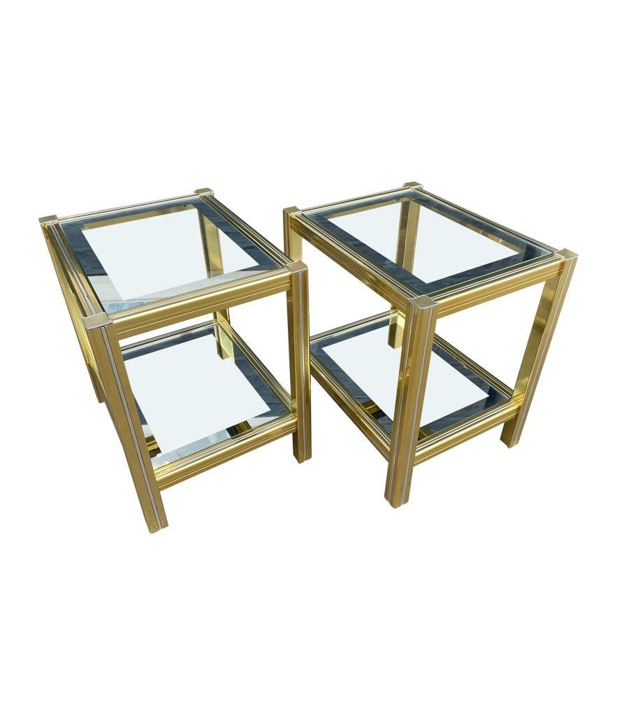 A pair of 1970s gilt metal and chrome side tables by Pierre Vandel, each with two orignal glass shelves with mirrored edges.