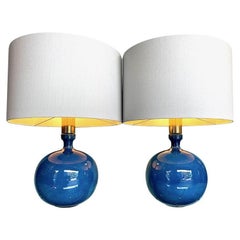 A pair of 1970s Italian blue ceramic lamps with brass necks and bespoke shades