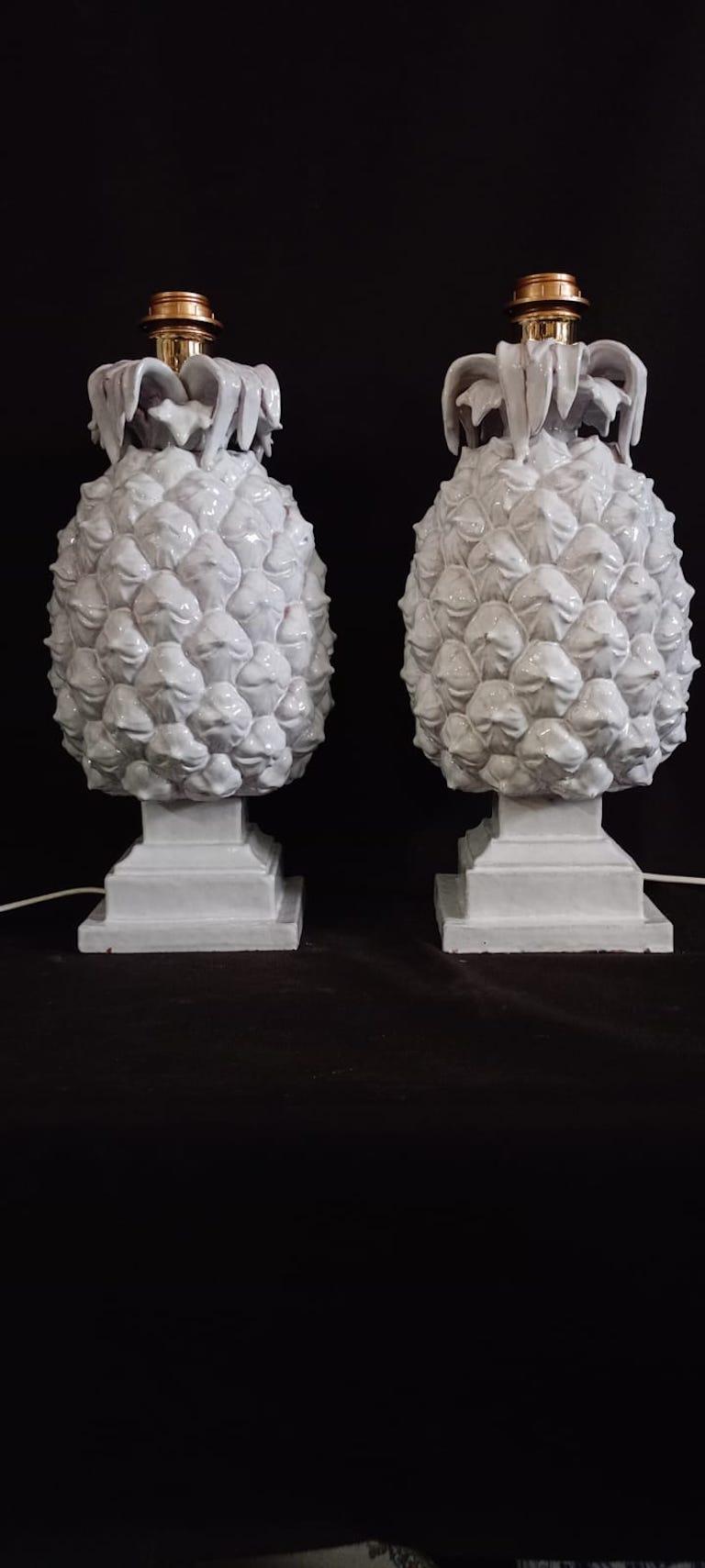 A pair of white glazed ceramic lamps in the shape of pineapple, wired to UK standards, lamp shades do not included. Italian c.70's