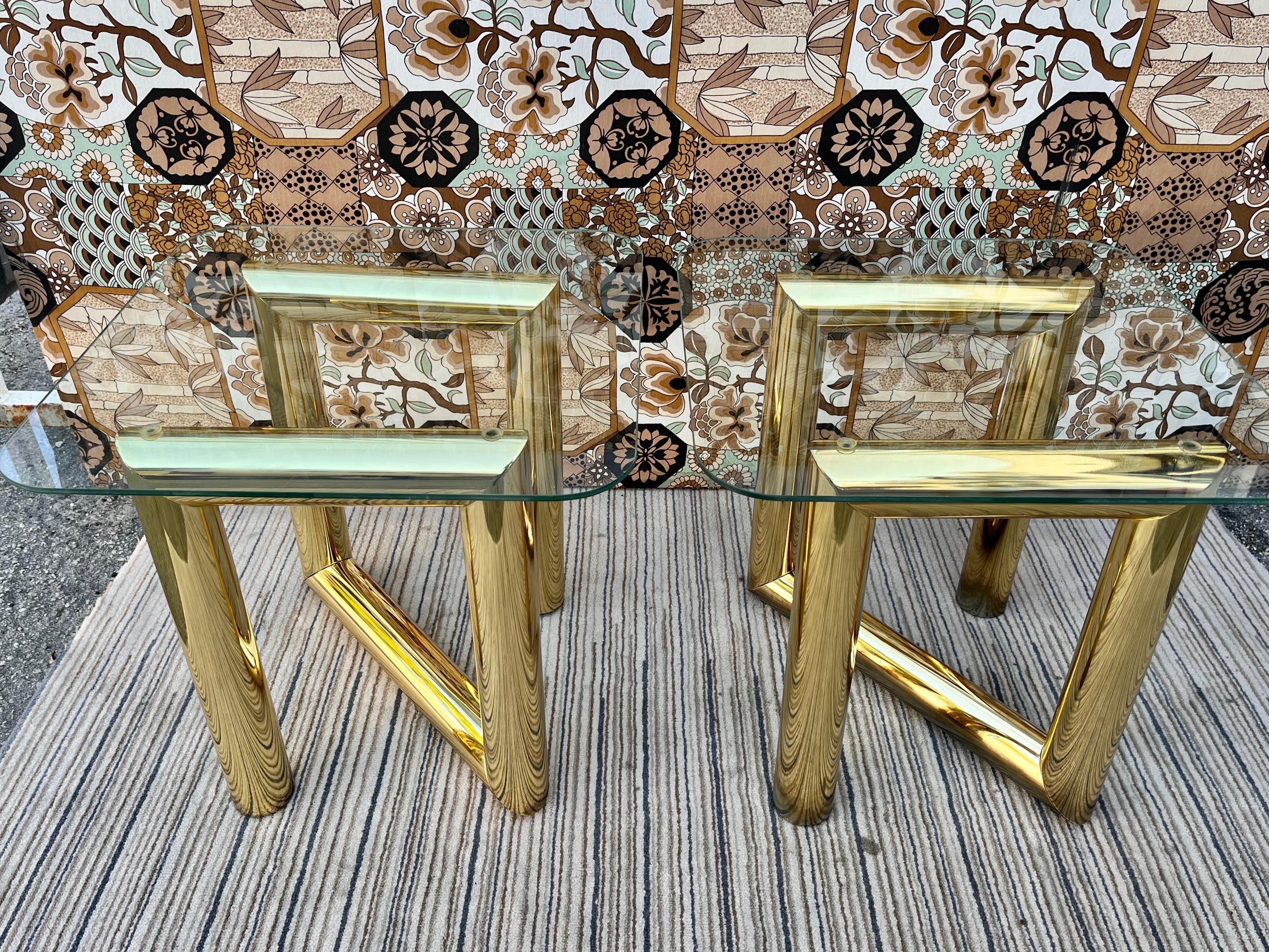A pair of Vintage Mid-Century Modern brass z tables with glass top in the Karl Springer's Style. Circa 1970s
Feature about 3 inches Z shaped tubular brass plated bases with removable square glass tops with rounded edges.
In good original cosmetic
