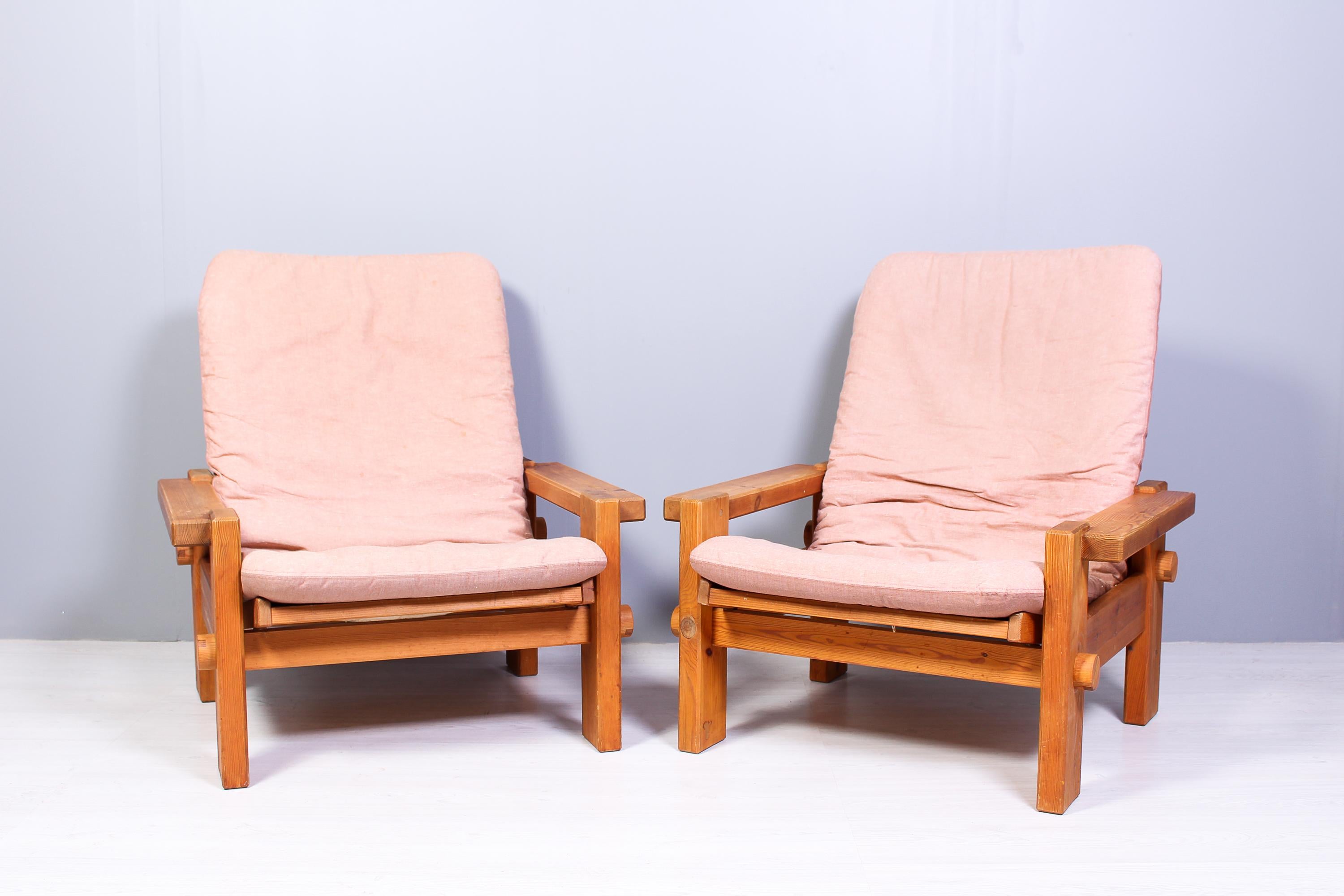 A pair of solid pine lounge chairs by Yngve Ekström, produced by Swedese in the 1970s. The brutal design and solid pine is the signature of this nice design by the well-known Swedish designer. The chairs has signs of usage and patina consistent with